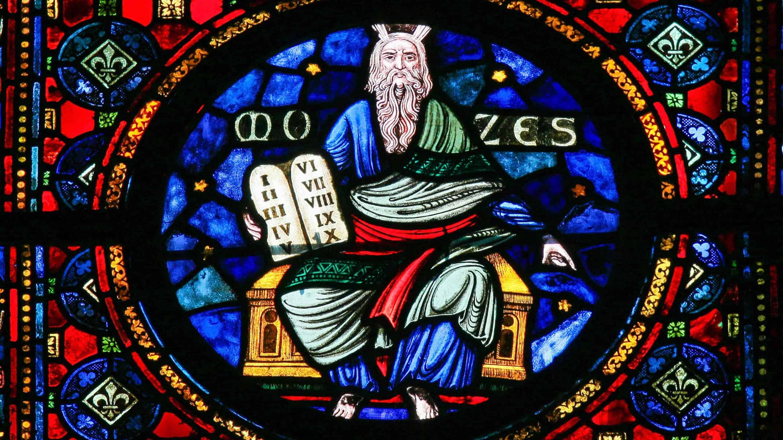 DINANT, BELGIUM - OCTOBER 16, 2011: Stained Glass window of Moses and the Stone Tablets with the Ten Commandments in the Church of Dinant, Belgium.