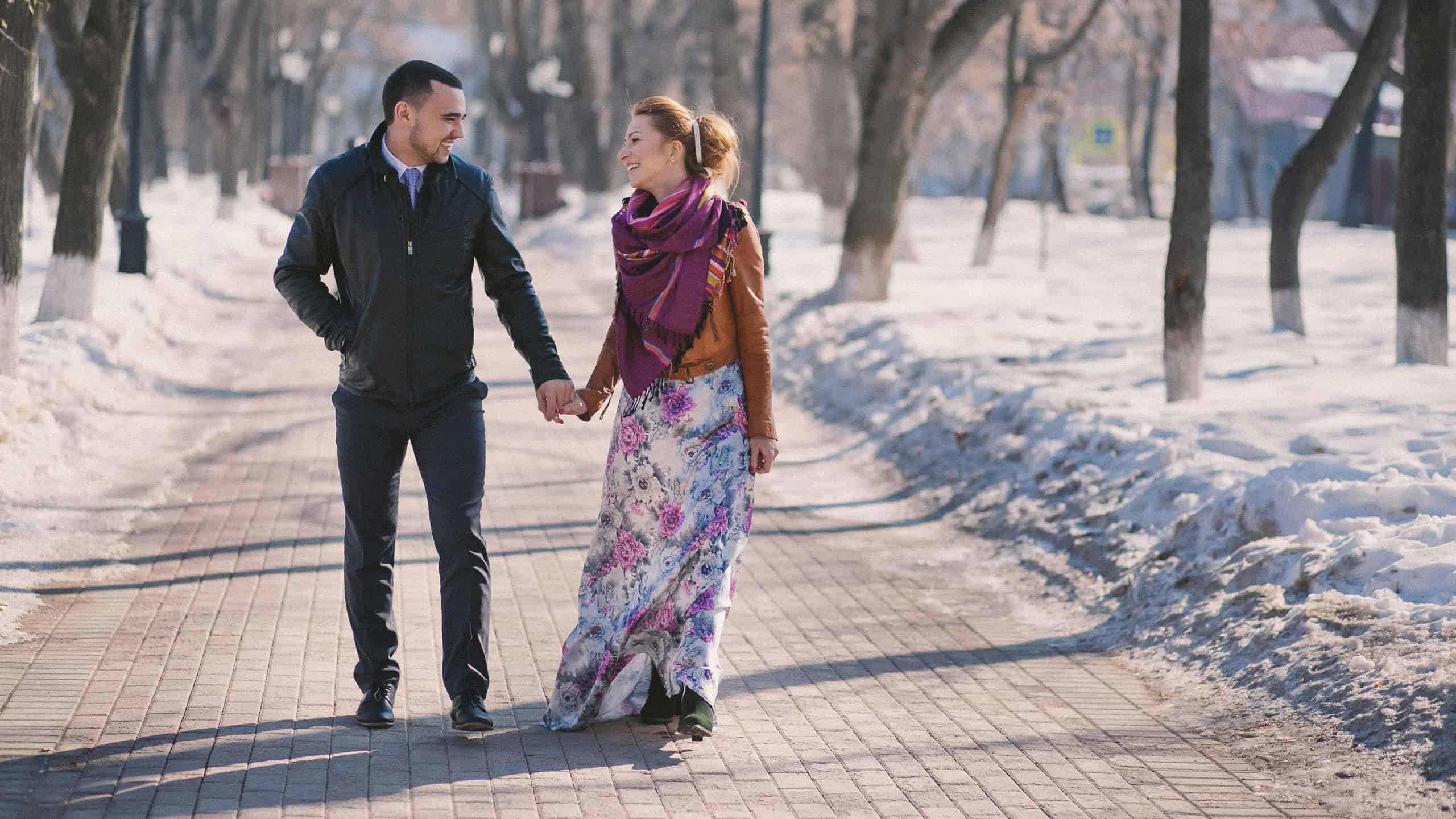 Happy young couple at first date taking a walk in nature. Vintage effect - film grain added