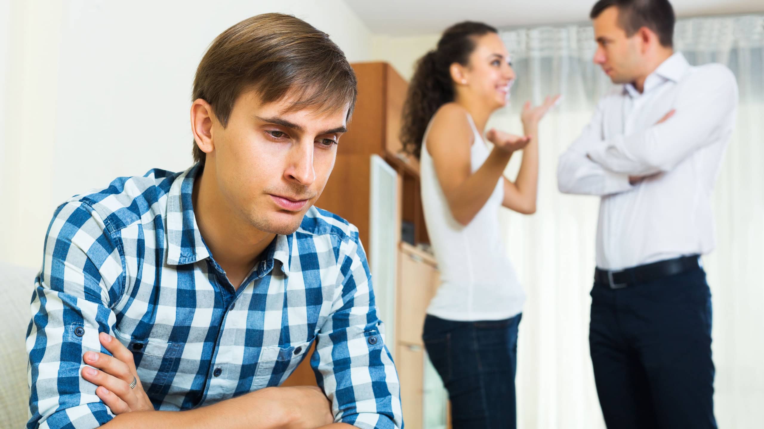 Unhappy ex-lover watching girlfriend leaving him for another man indoors