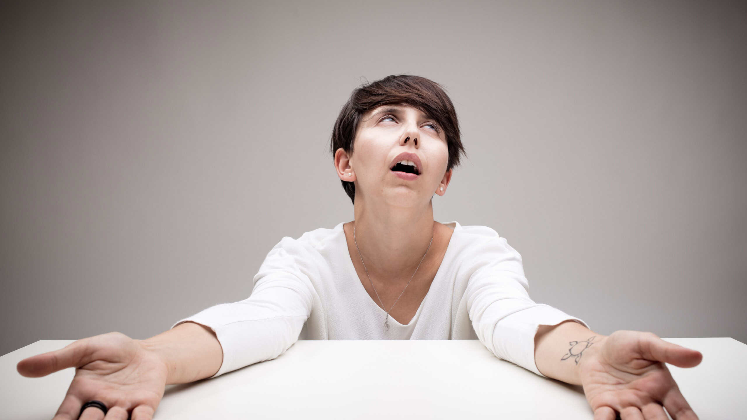funny expression of an exhausted woman praying heaven's mercy because she can't stand it anymore