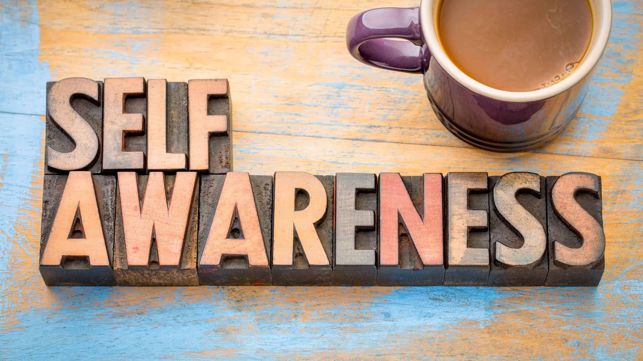 Self awareness word abstract in vintage letterpress printing blocks with a cup of coffee