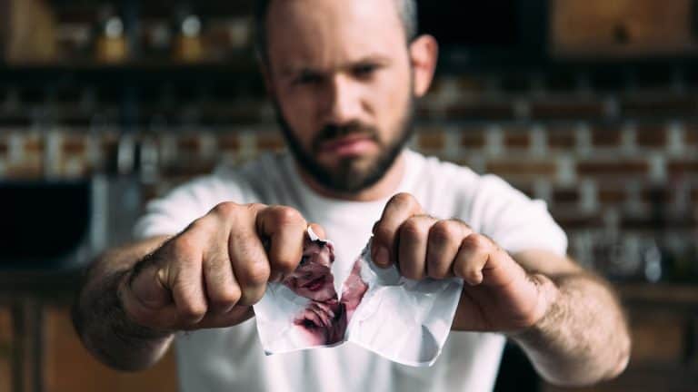 close-up shot of angry young man tearing photo of ex-girlfriend