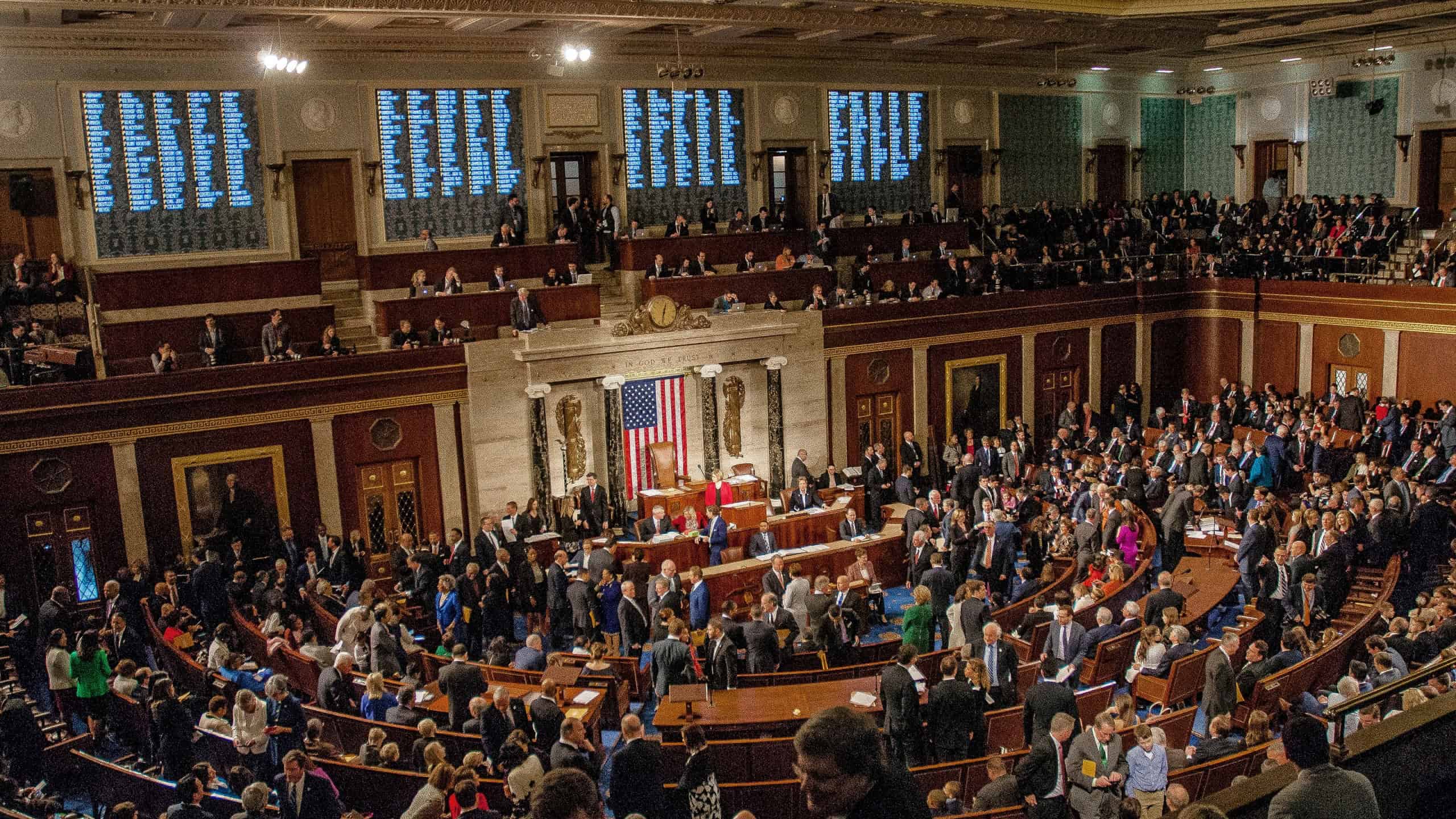 Members of the 115th congress and their familes mingle on the house floor while attending the joint session on the opening day of the current session.