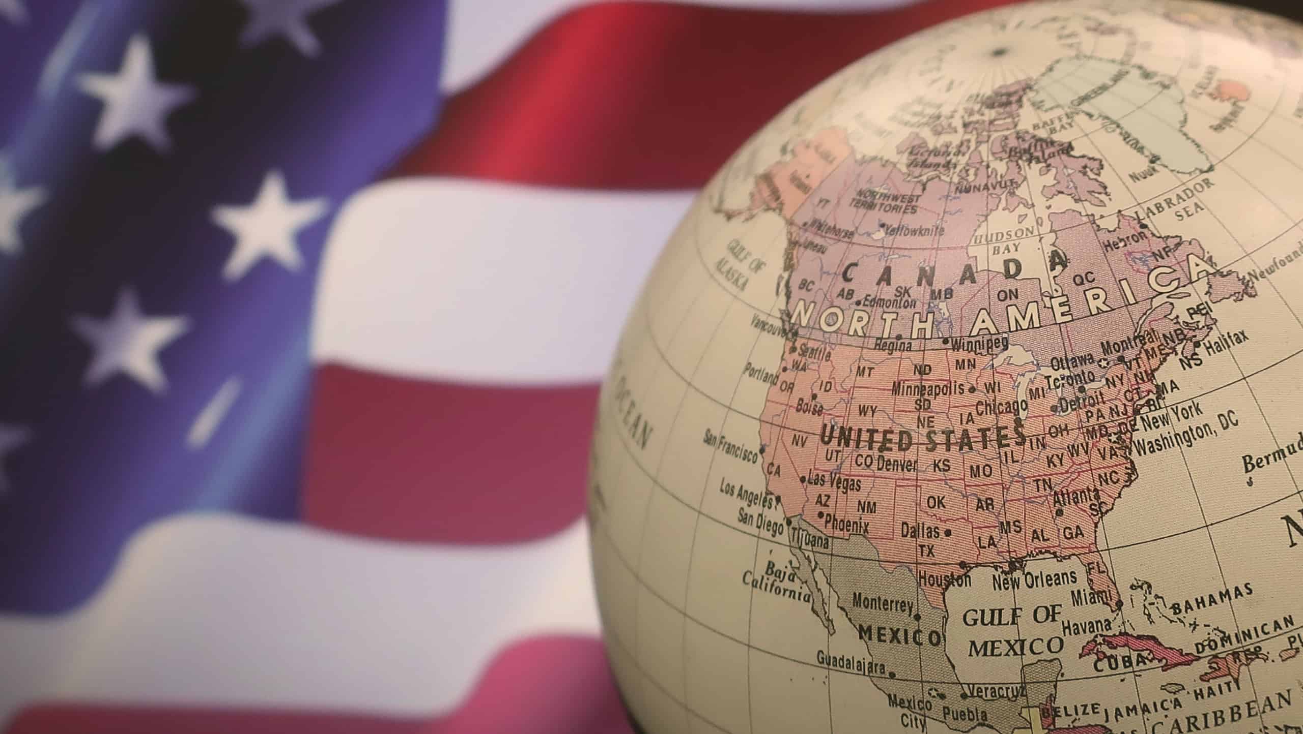 close up of globes with American Flag background.