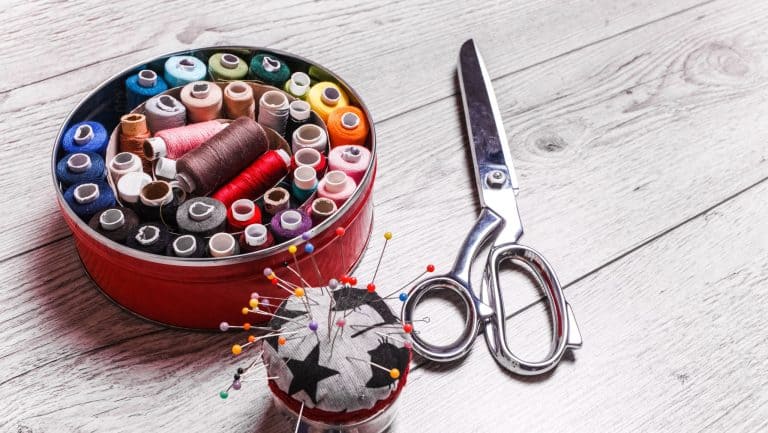 Tools for sewing. Sewing accessories on wooden background.