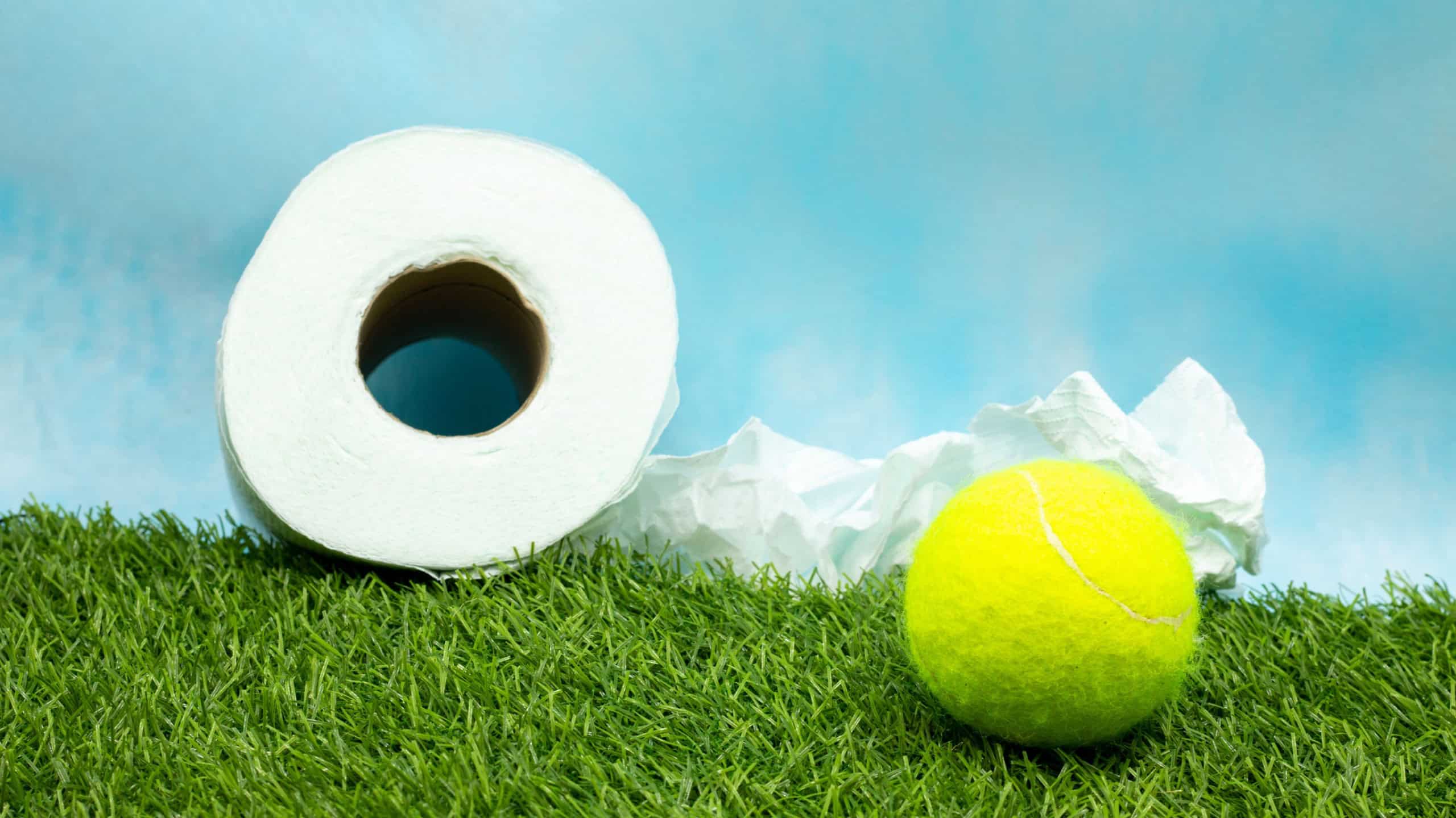 Tennis ball with toilet tissue paper on blue background
