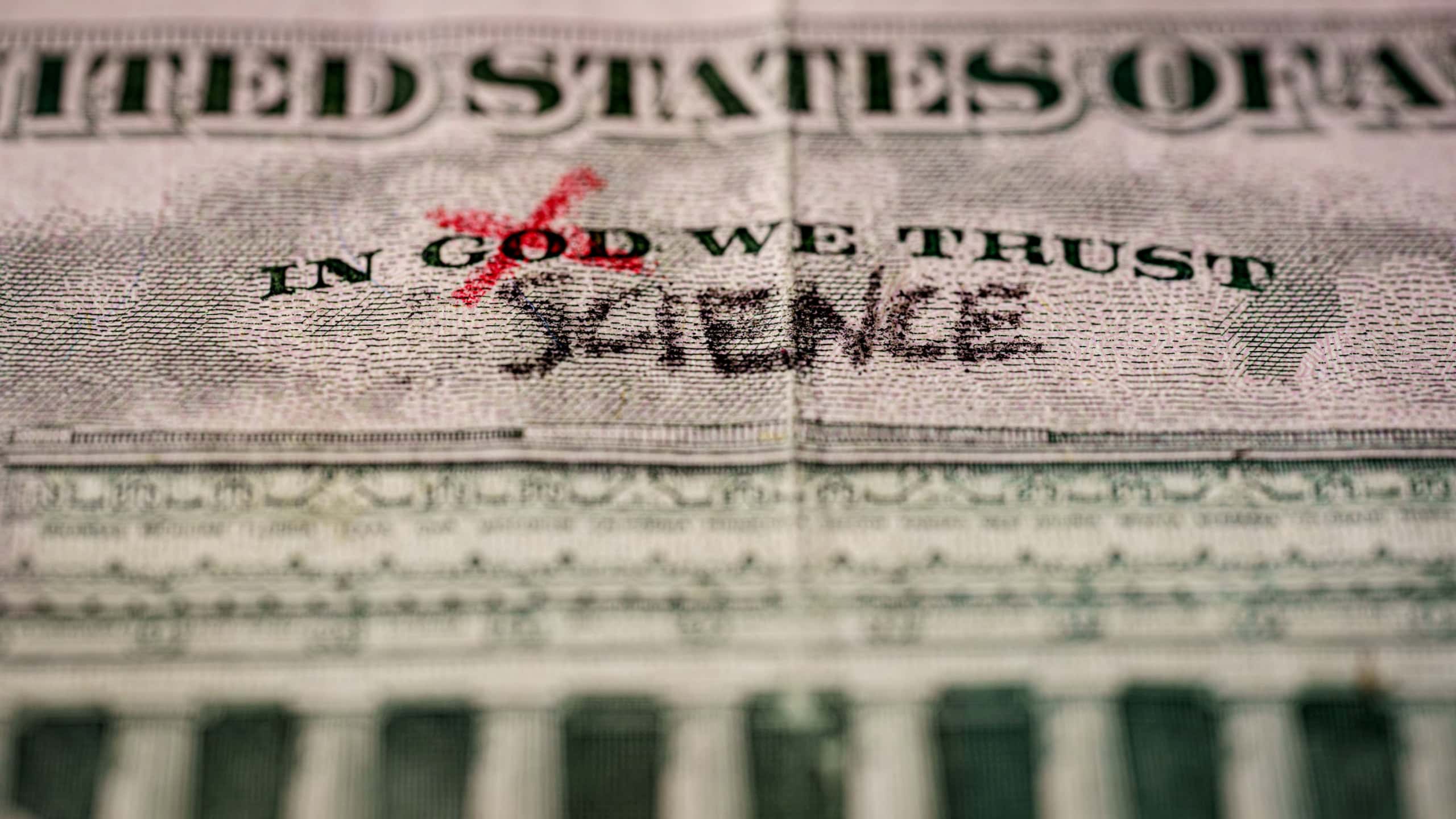 Word God crossed out and replaced by science on a US dollar bill. Suitable for atheism, coronavirus vaccine or science as new rellgion concepts.