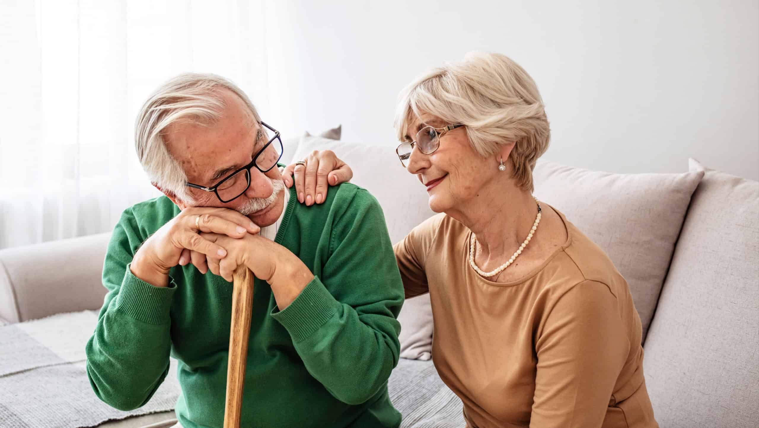 Shot of a senior woman comforting her husband at home. Elderly couple comforting each other. Confused Senior Man Suffering With Depression And Dementia Being Comforted By Wife