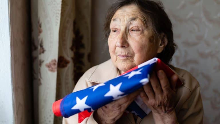 Senior who is proud to be an American, very old woman with american flag.