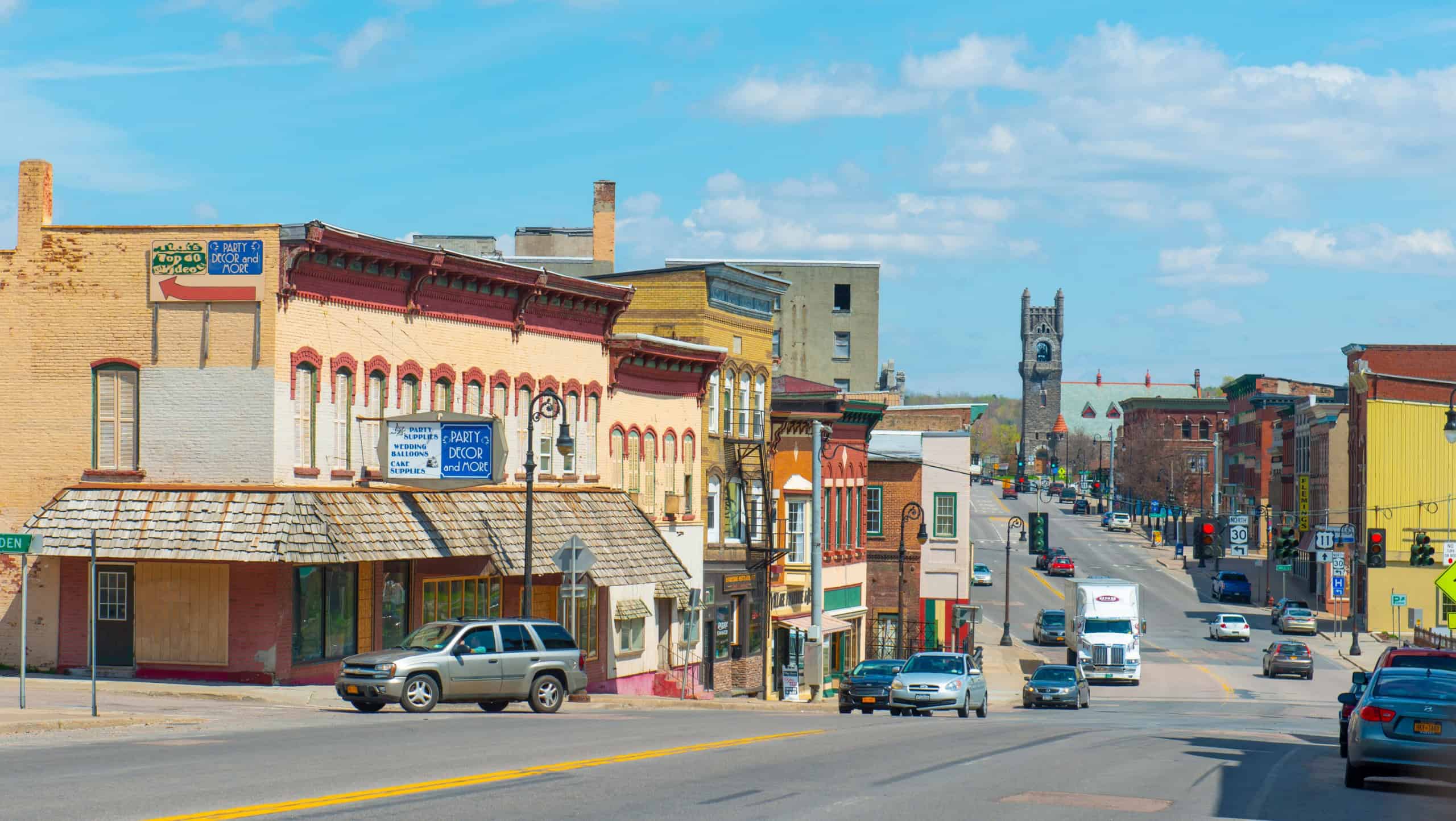 MALONE, NY, USA - APR. 29, 2017: Historic sandstone and brick commercial buildings with Italianate style on Main Street in downtown Malone, Upstate New York NY, USA.