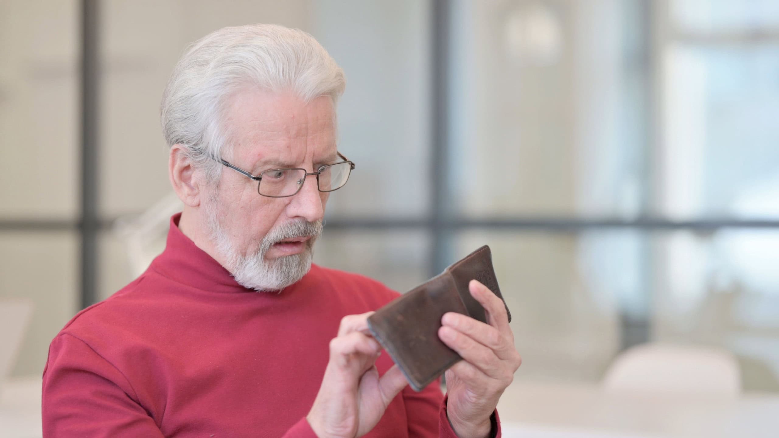 Old Man Checking Empty Wallet at Work