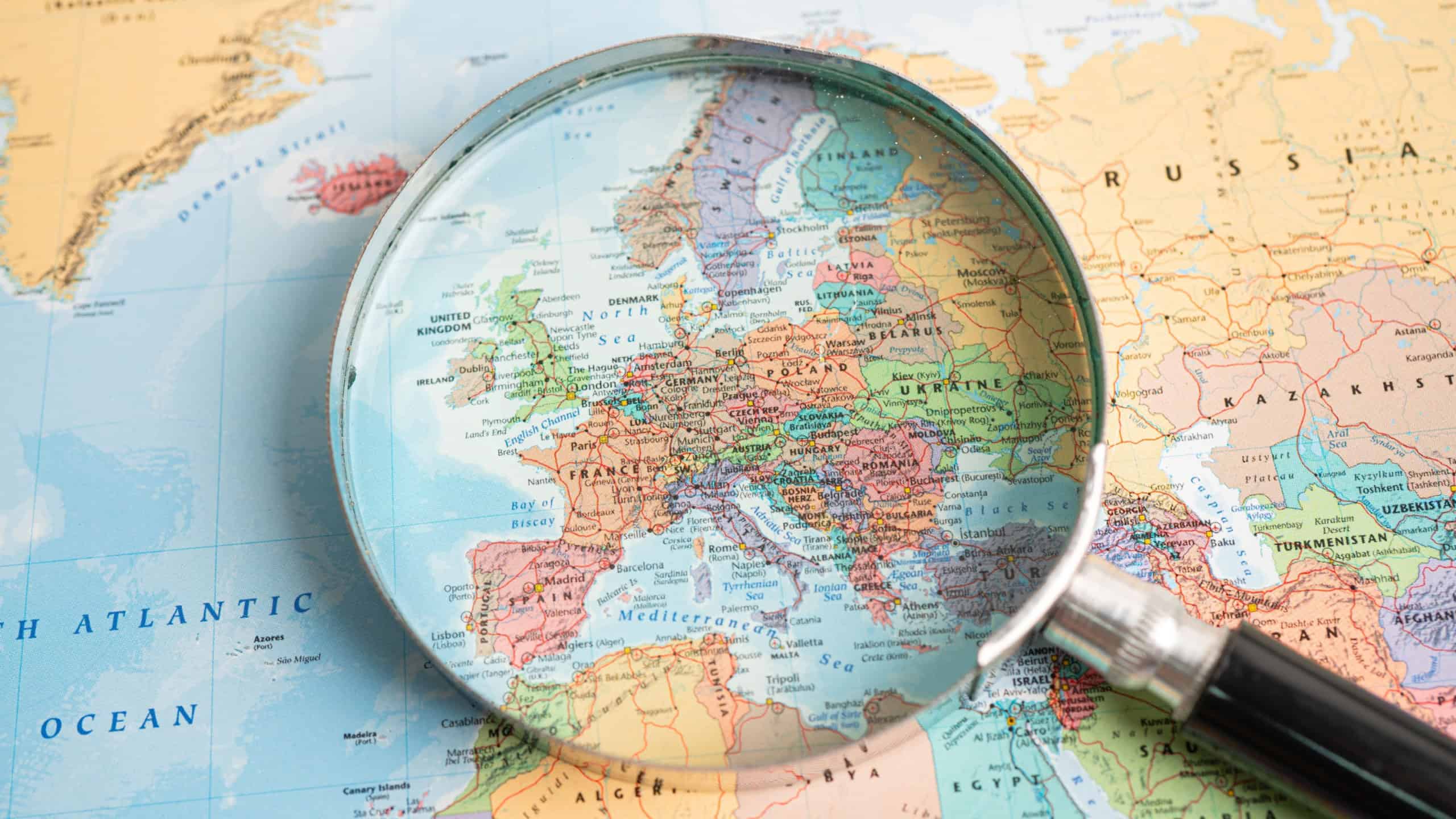Magnifying glass close up with colorful world map