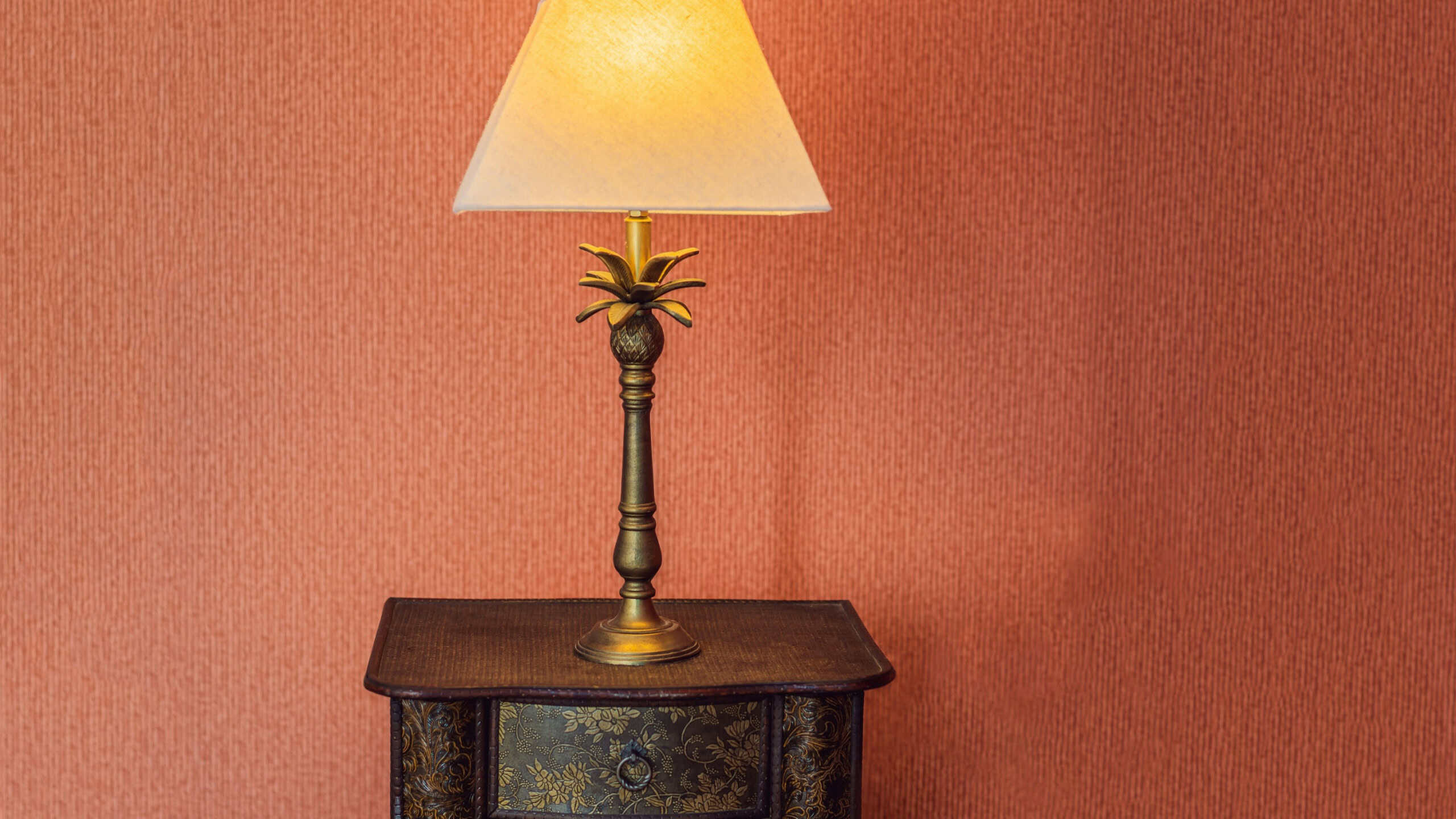 Bright eco light in the corner of a modern bedroom. New led technology meets traditional interior design. Lamp is creating cozy atmosphere in room. Wooden, glass table, blue curtains