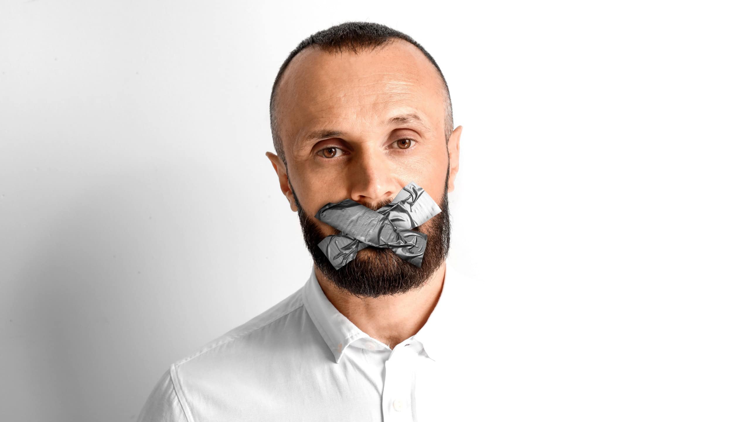 Mature man with taped mouth on white background. Speech censorship