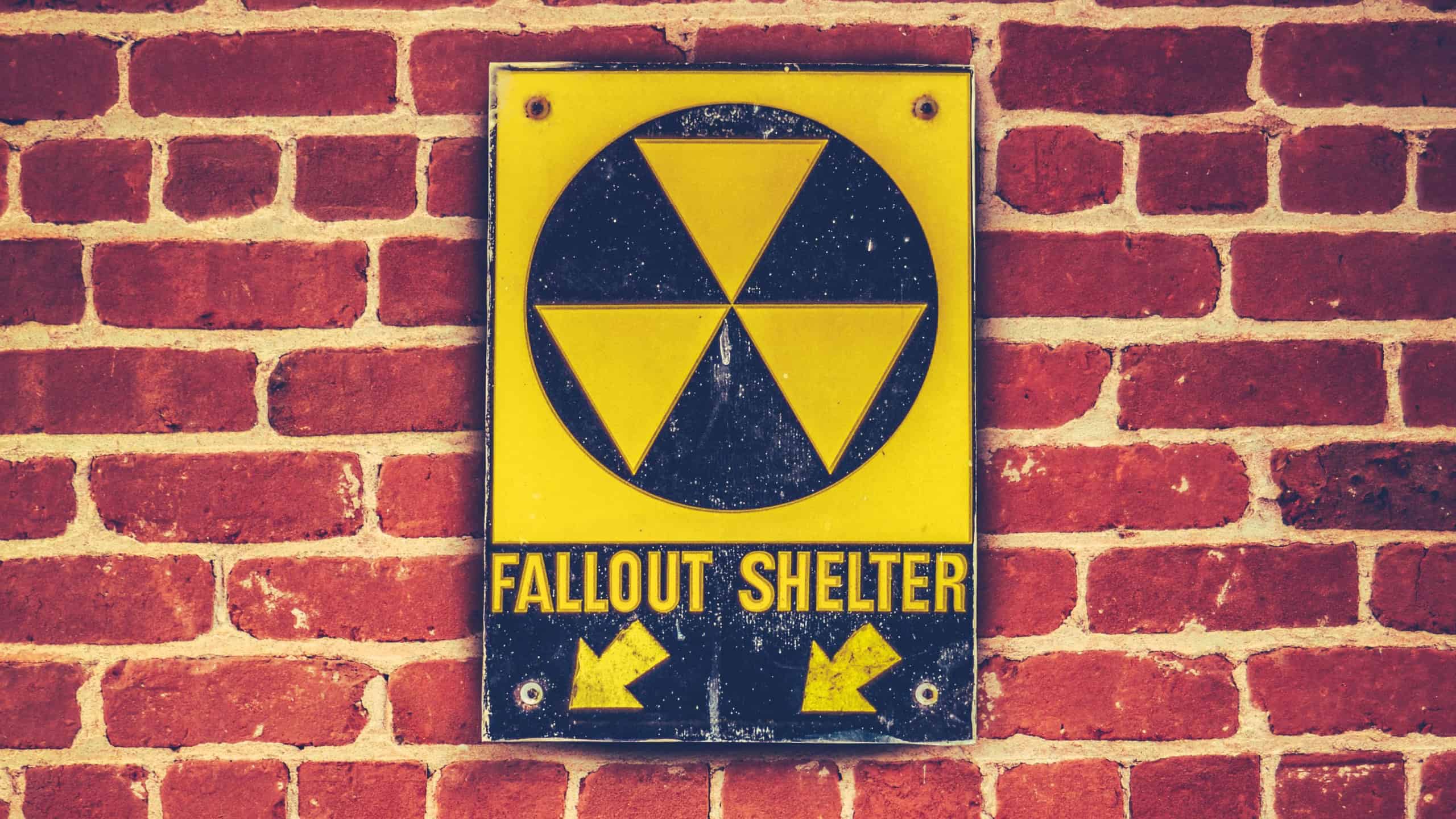 Retro Styled Nuclear Fallout Shelter Sign On A Red brick Wall
