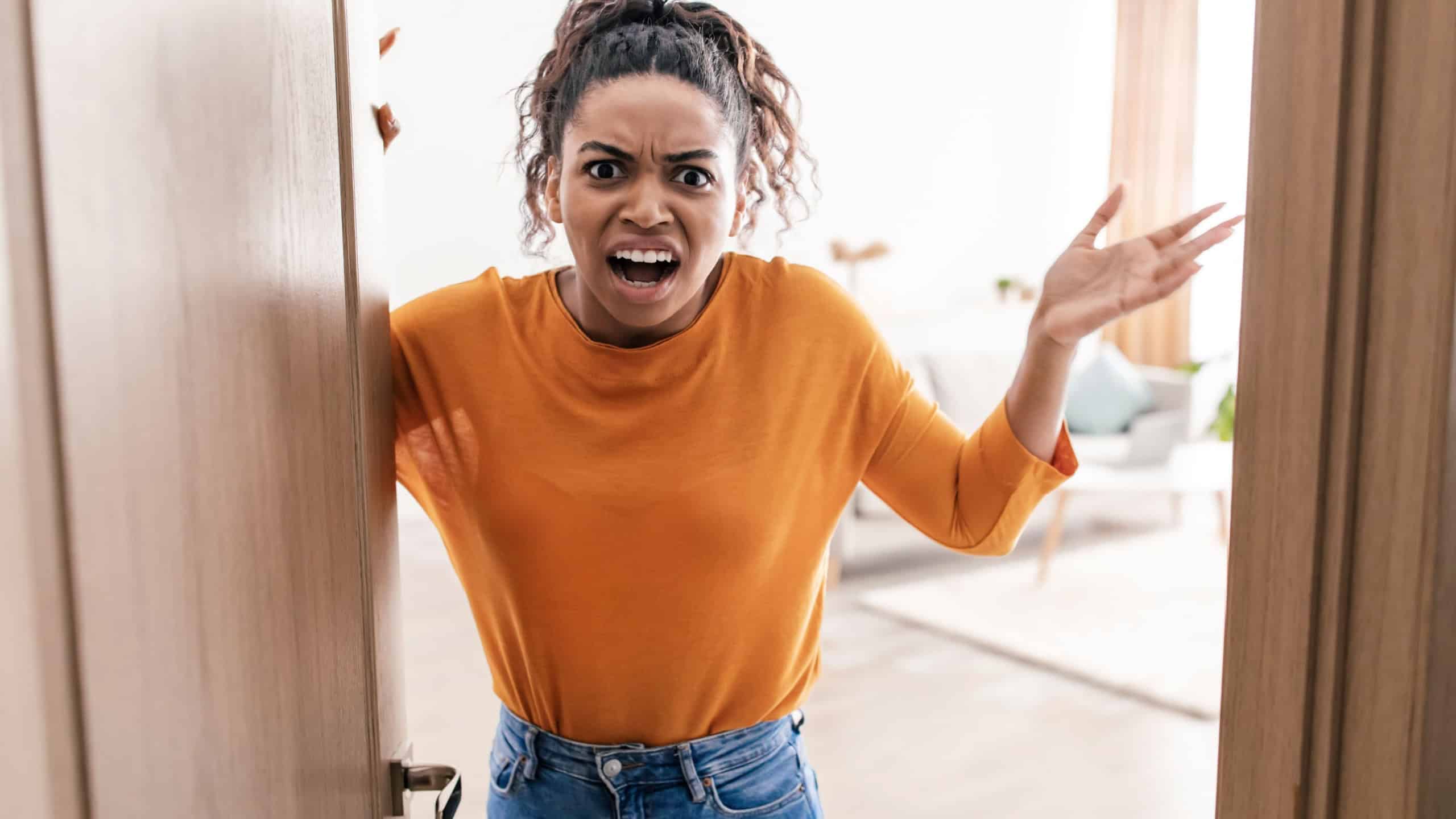 Angry Black Female Shouting Standing In Opened Door Looking At Camera In Anger, Having Problem At Home. Real Estate Ownership Issue Concept.