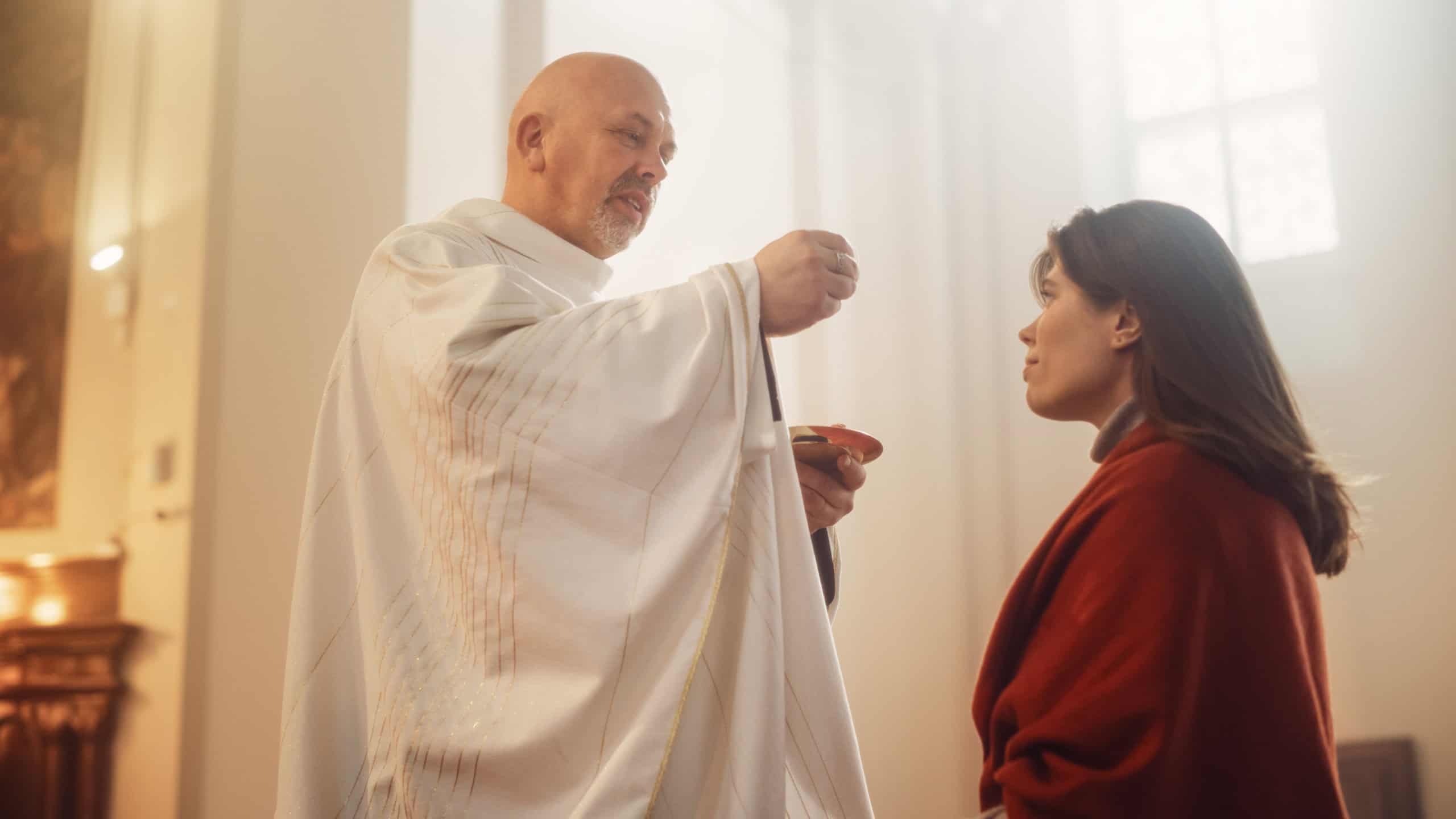 In Church Ceremony of Holy Communion, Eucharist or Last Supper: Christian Minister Breaking bread, Giving it to Parishioner, act of Unity with Jesus Christ, Saviour Who Sacrificed Himself for People