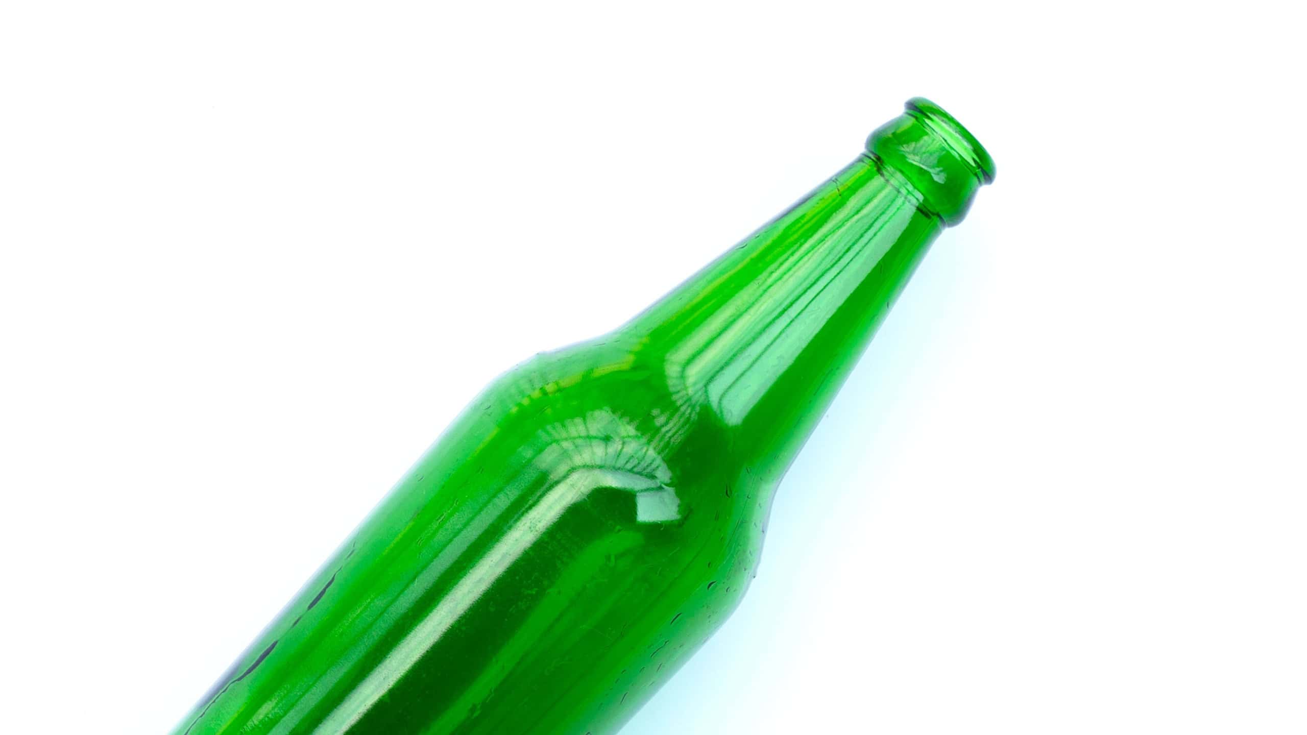 Green glass bottle on white background.