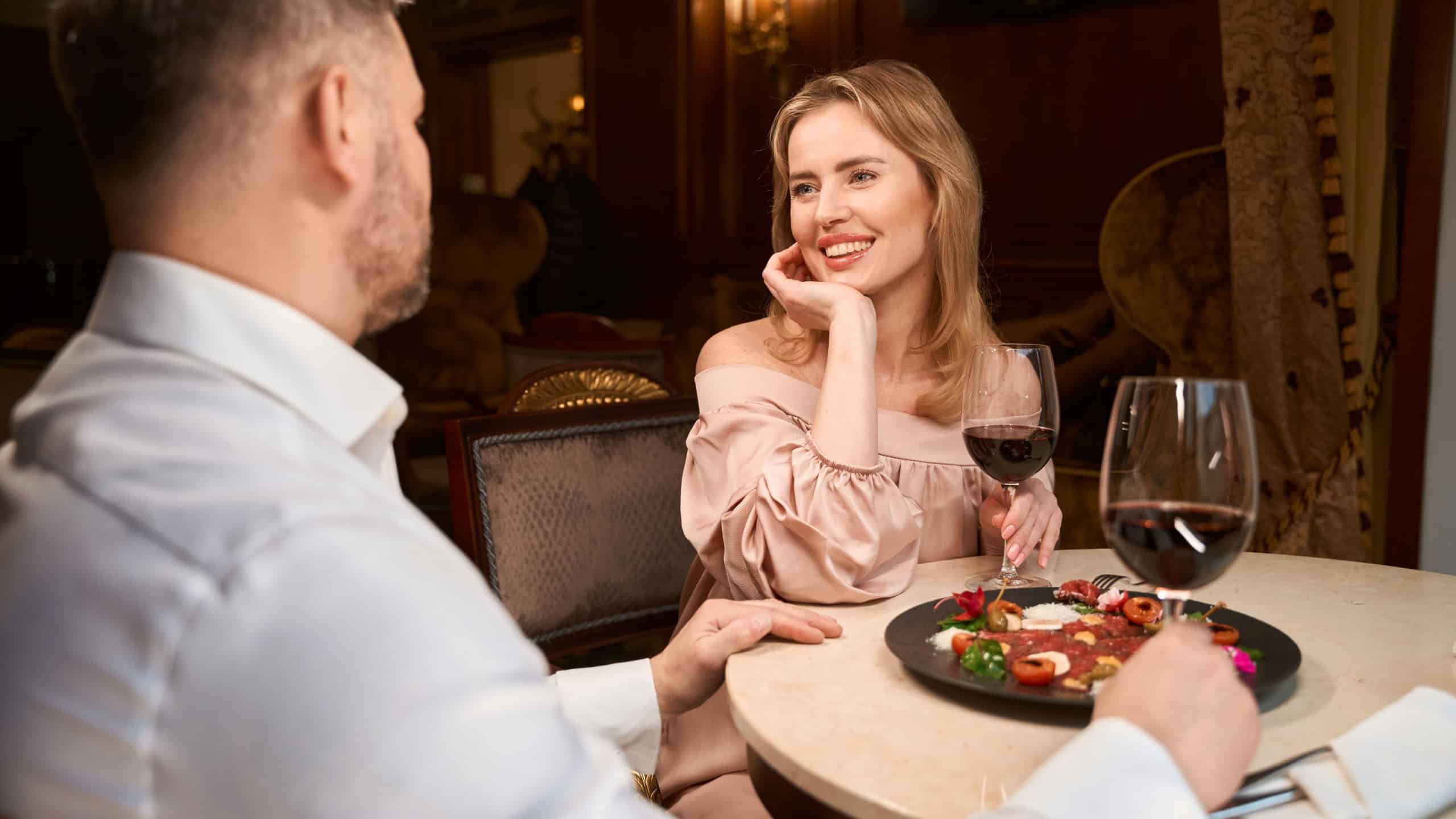 Happy lovely couple having romantic dinner in the luxury restaurant