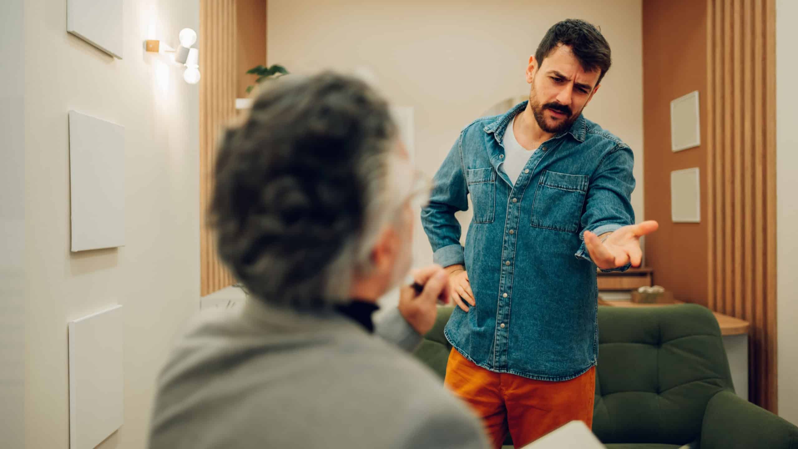 A young client is rejecting help and going through resistance with his shrink at the doctor's office. A patient is rejecting medication and therapy while standing at a shrink's office.