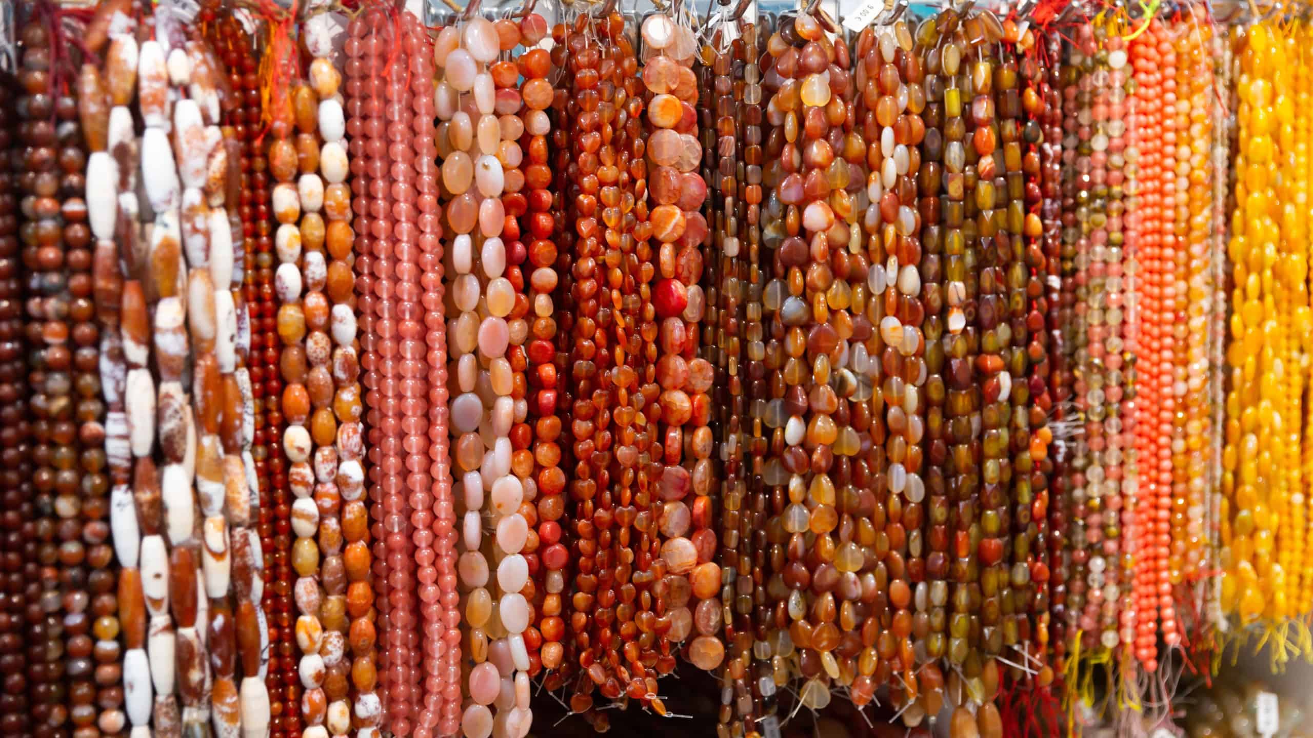 Beads from various gemstones on the showcase of a jewelry store