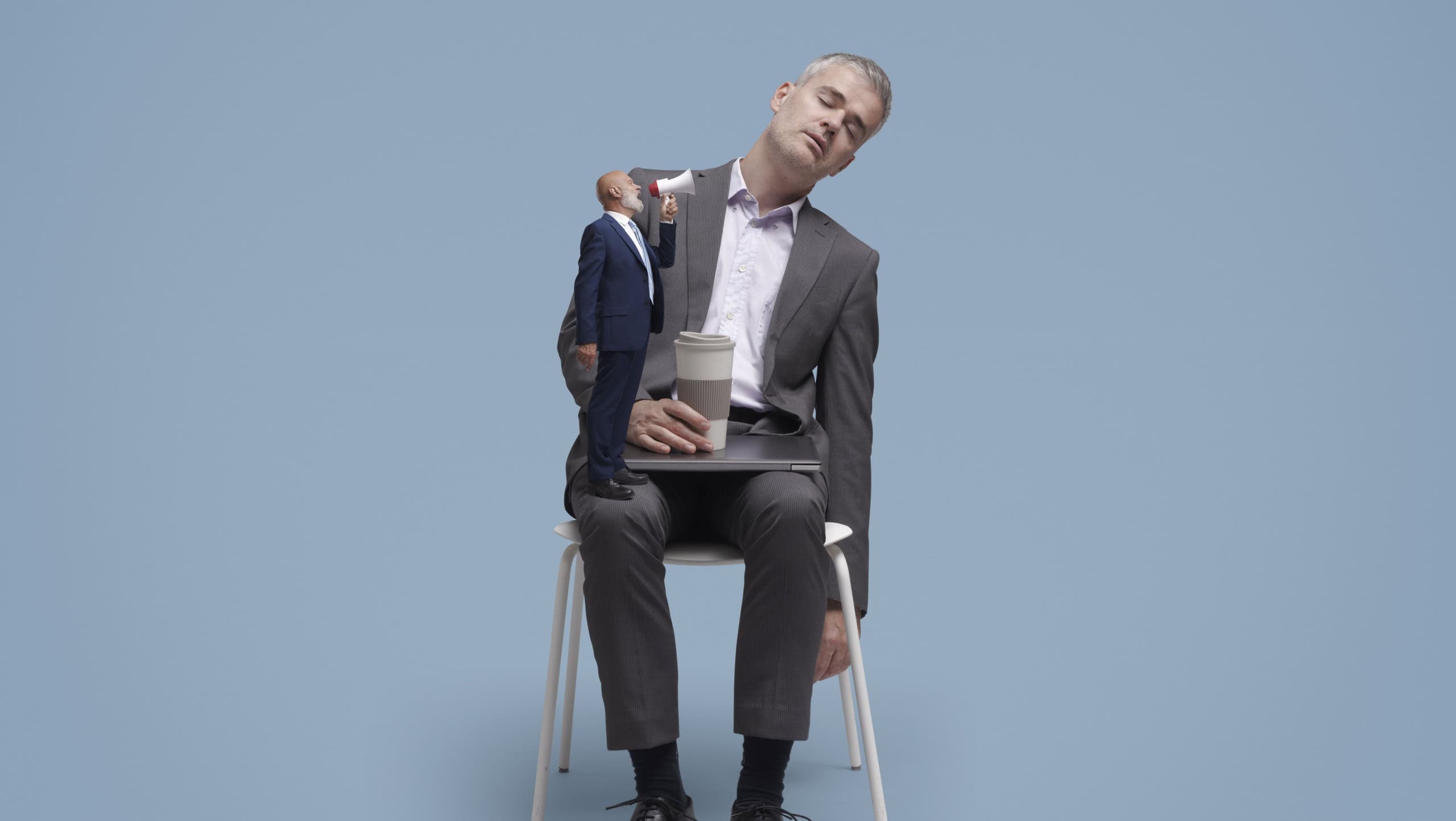Tiny boss shouting at his sleepy lazy employee using a megaphone