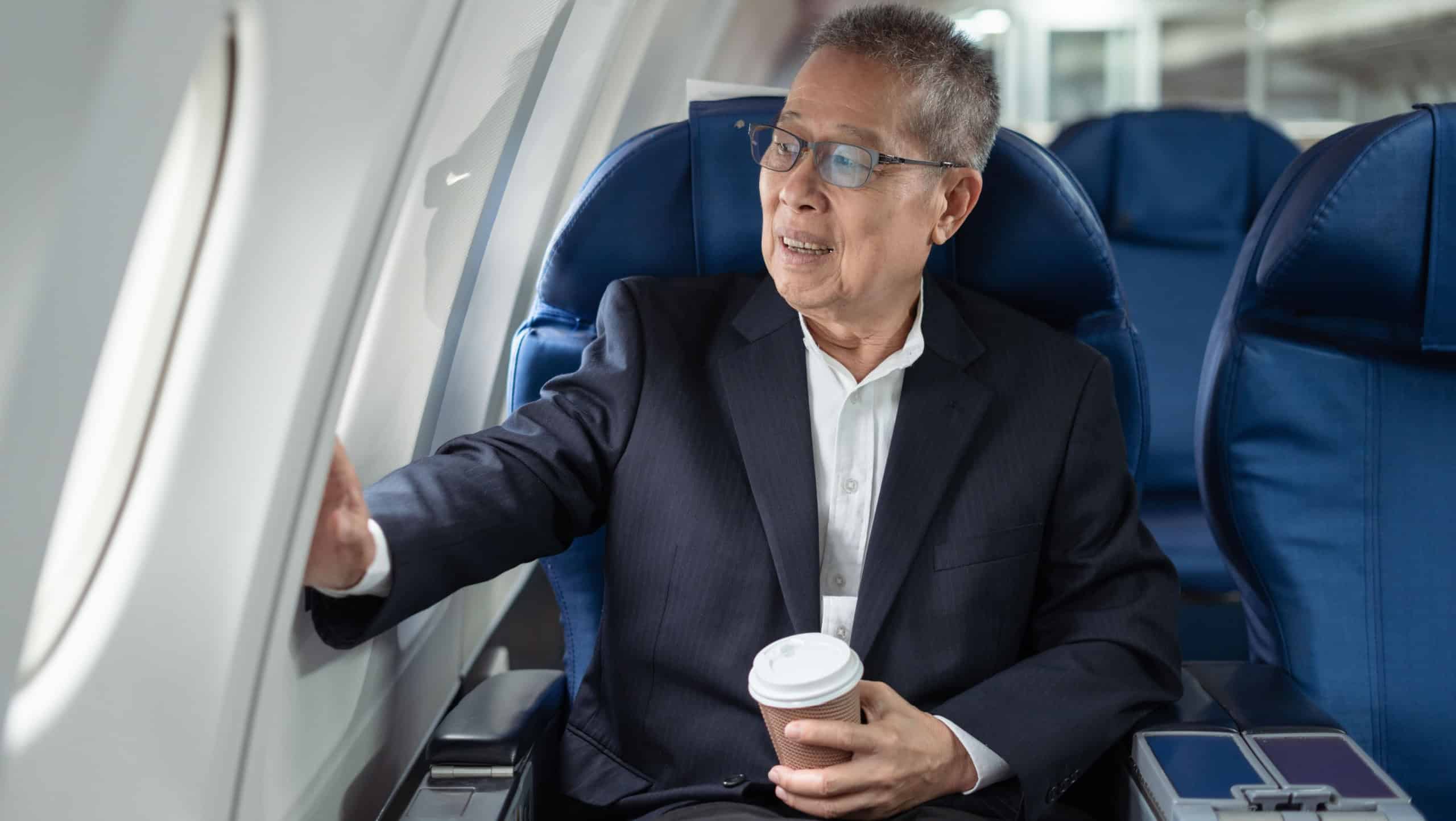 Successful business man, Airplane, travel, enjoying comfortable flight while sitting in the airplane cabin.
