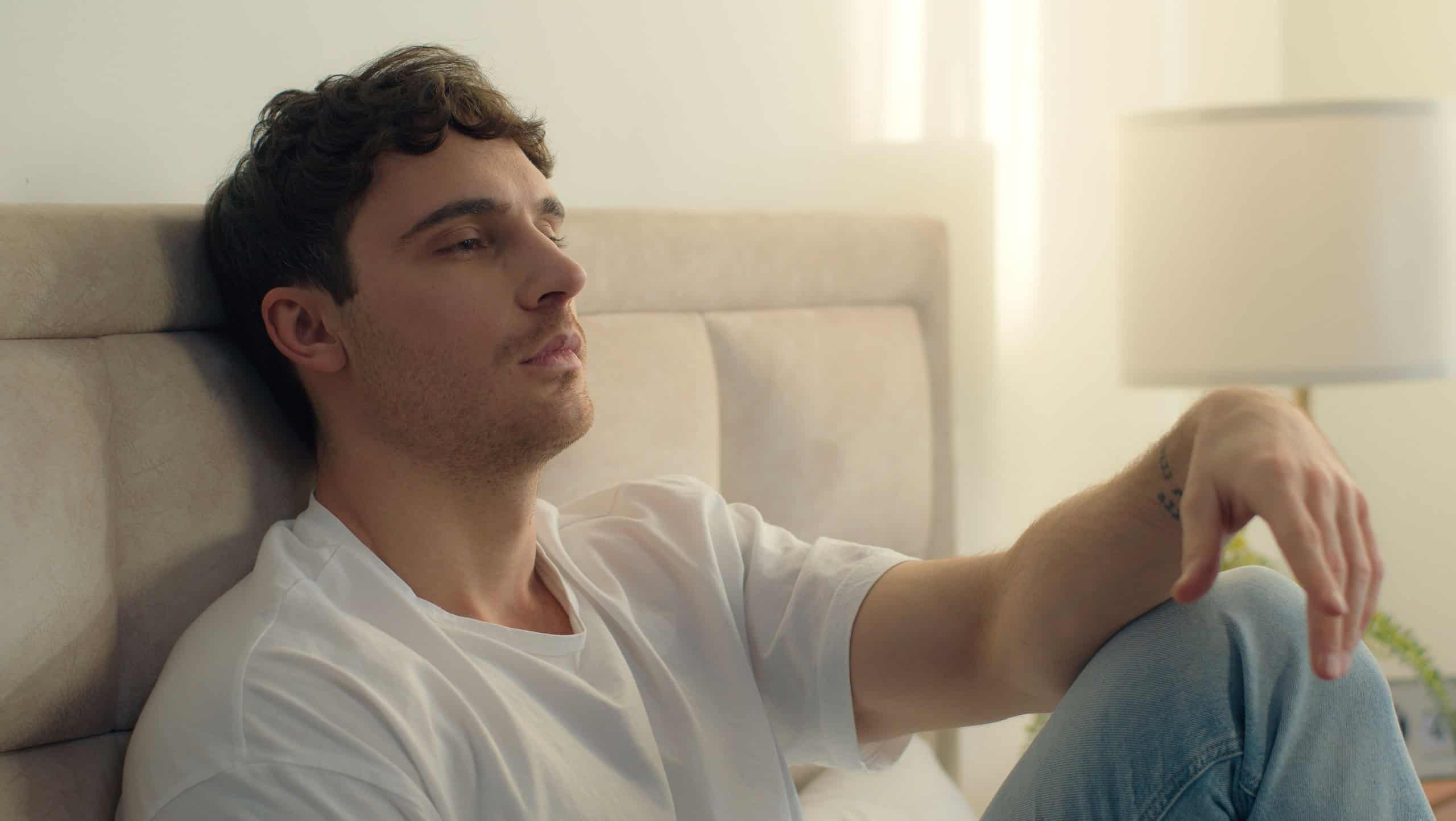 Caucasian European man pensive thoughtful thinking sadness bored bedroom bed home male tired guy failure grief loneliness upset sigh contemplation boredom reflection solitude frustration exhaustion