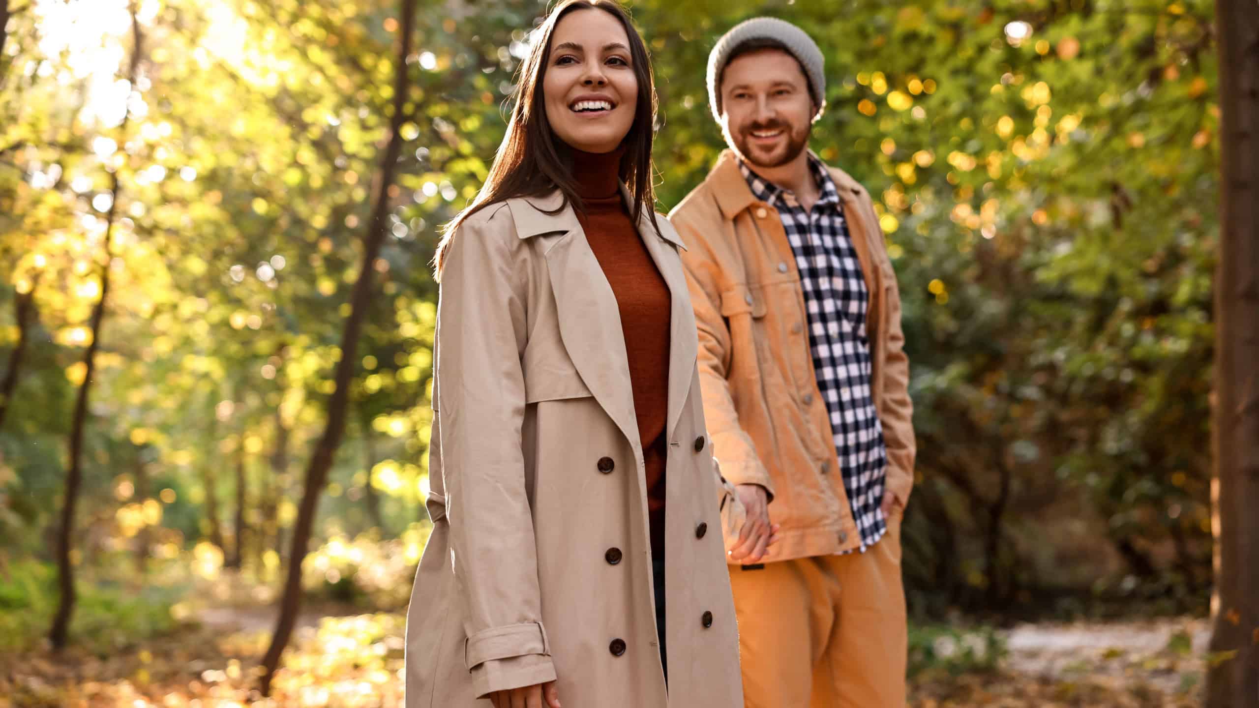 Beautiful couple walking together in autumn park