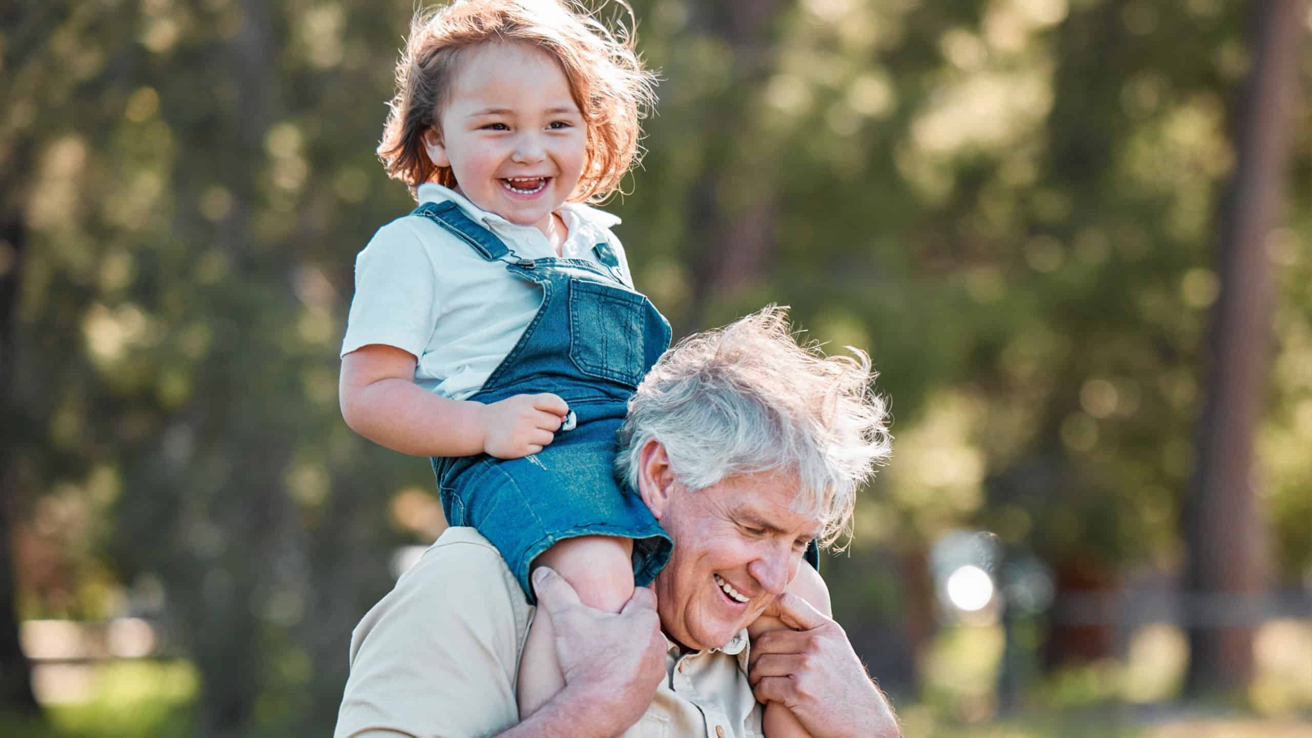 Carry, laughing or shoulders with boy and grandfather outdoor in nature together for bonding. Funny, love or smile with happy senior man and grandchild walking in garden or park for relationship
