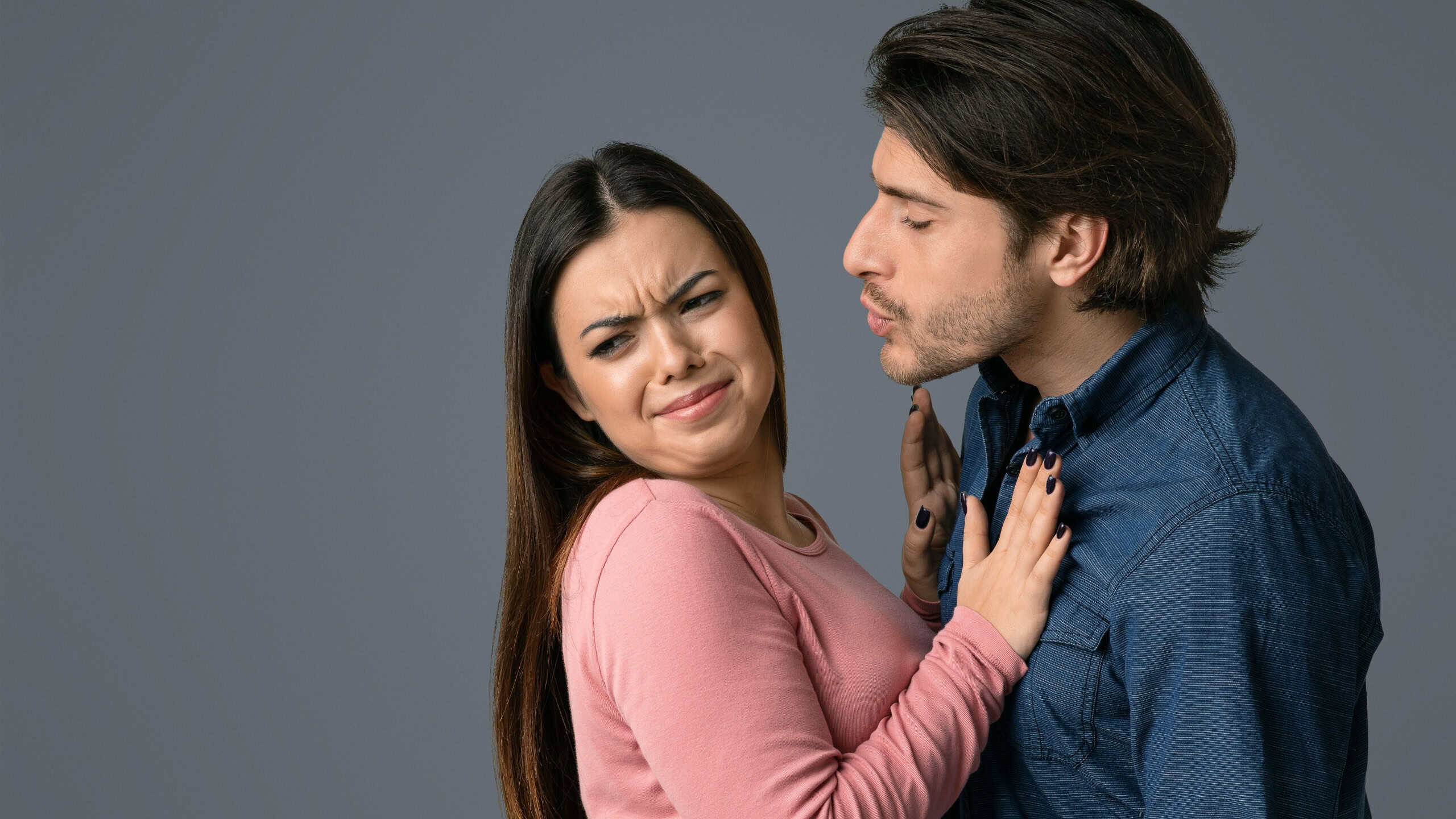 Fear Of Coronavirus Spread. Displeased Young Woman Rejecting Kisses From Her Boyfriend, Afraid Of Respiratory Infections