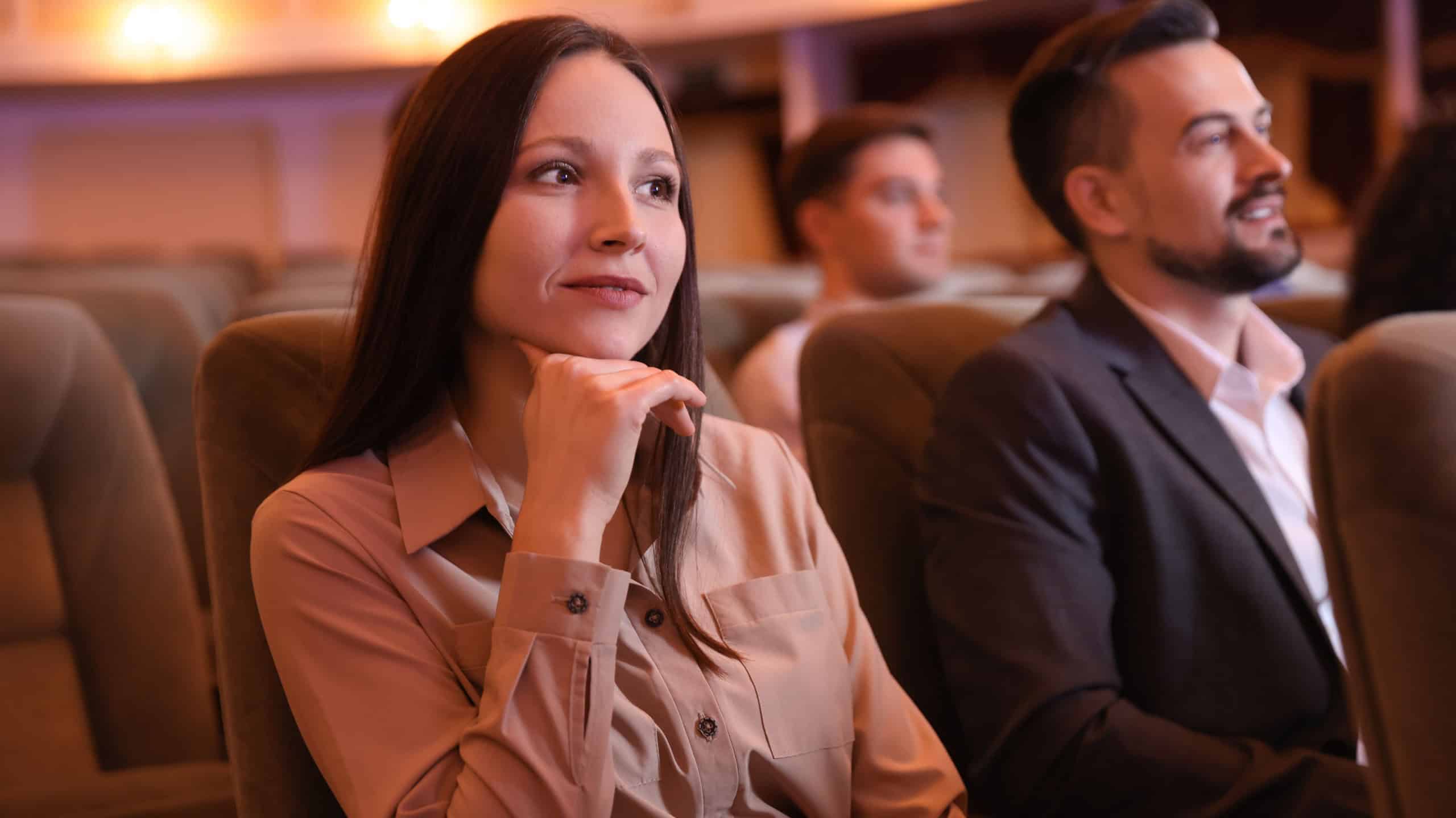 Group of people watching theatrical performance in theatre