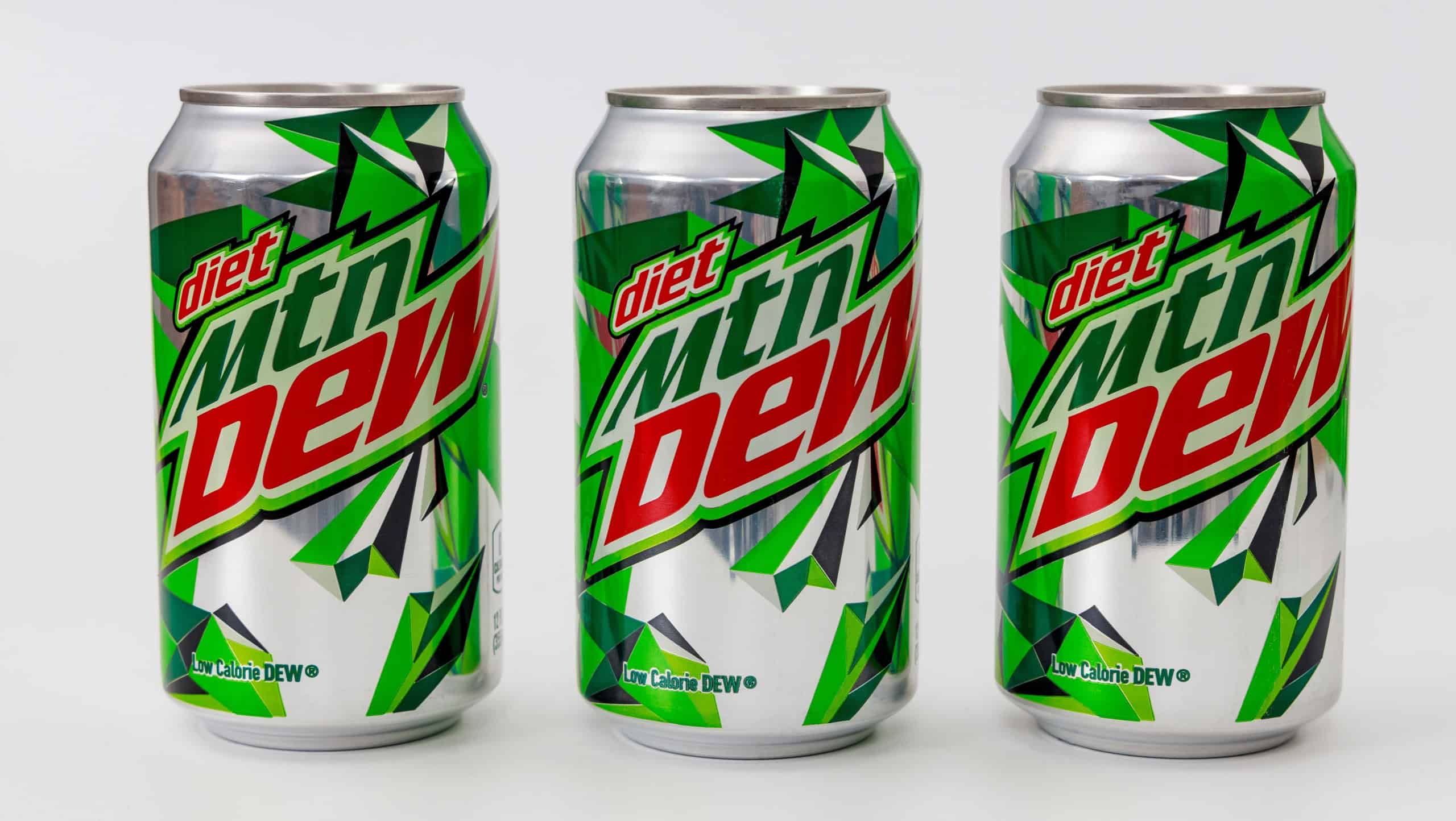 March 6, 2023. Spartanburg, SC USA. Three cans of Mtn Dew diet soda arranged in row, showcasing their vivid green and silver design.