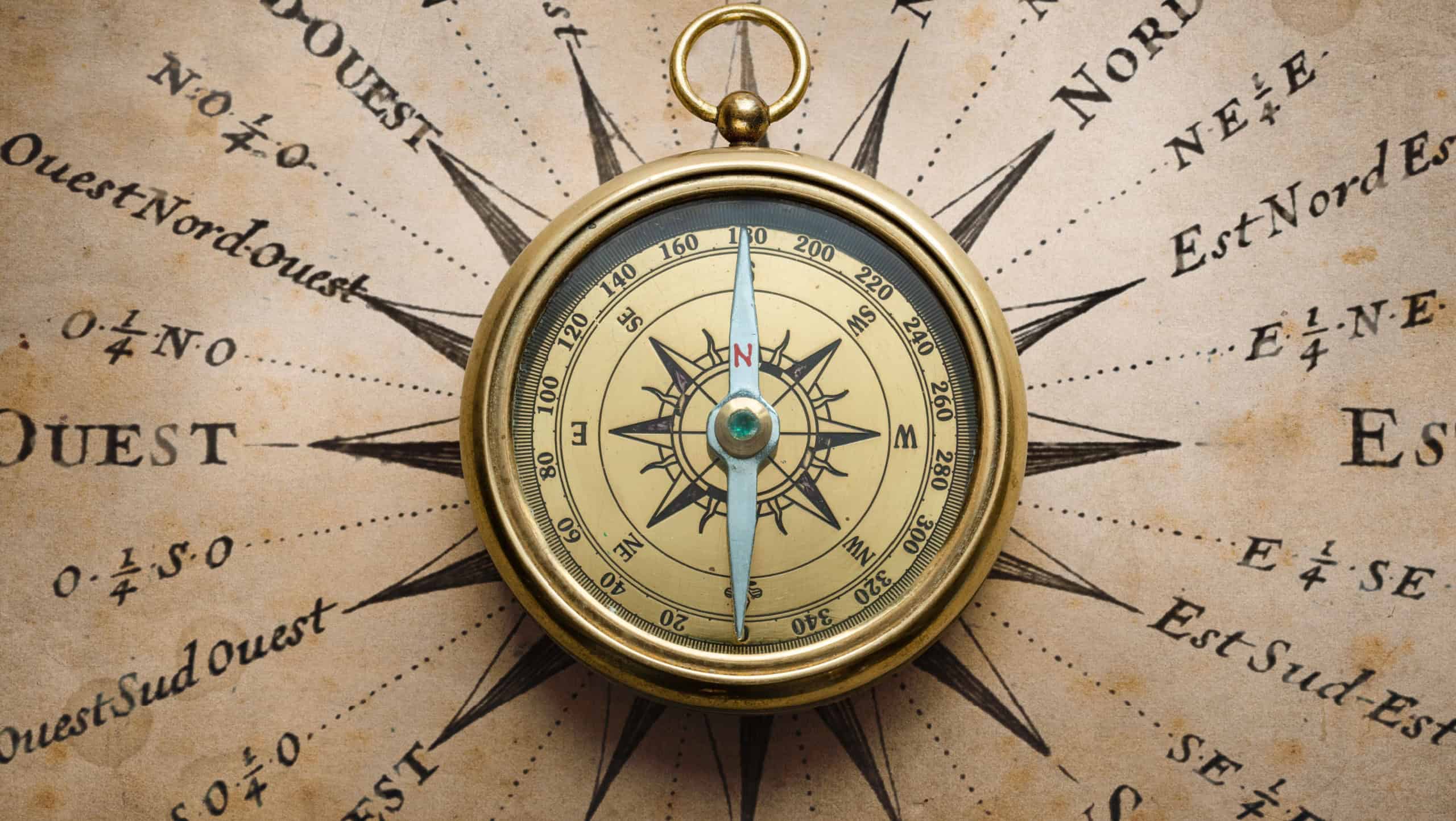 Magnetic old compass on map. Travel, geography, history, navigation, tourism and exploration concept background. Retro compass on geography map.