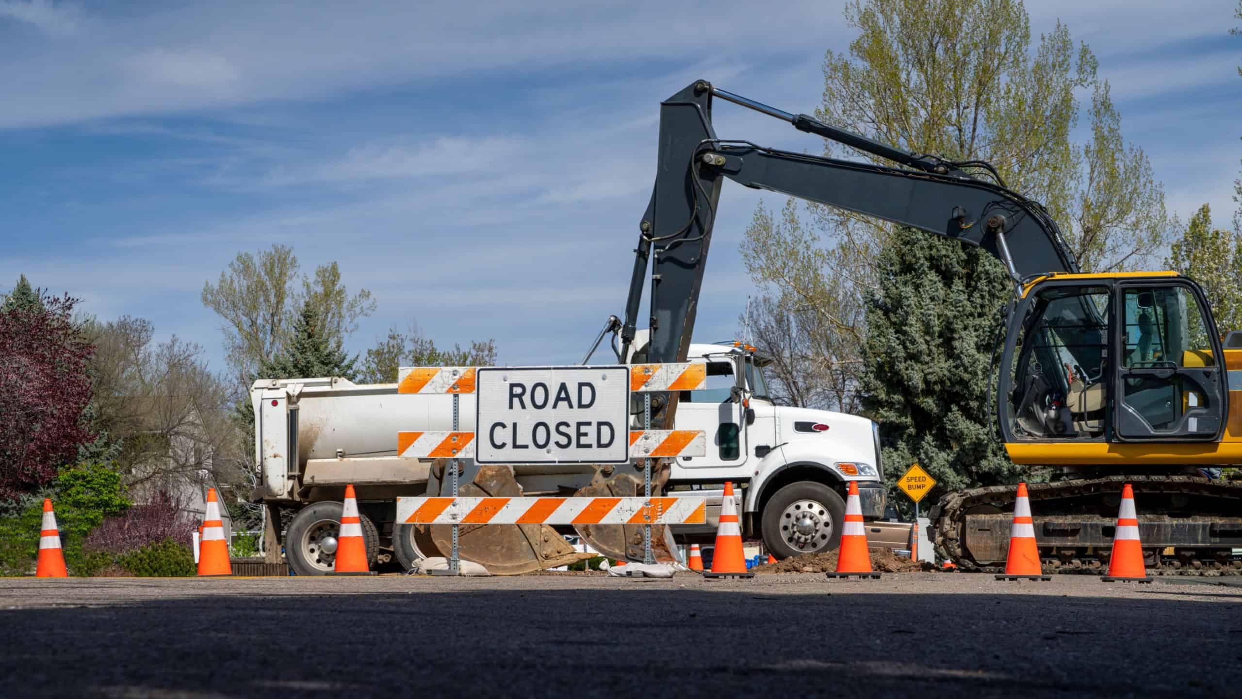 Road closed - sign and barrier on a residential street for construction