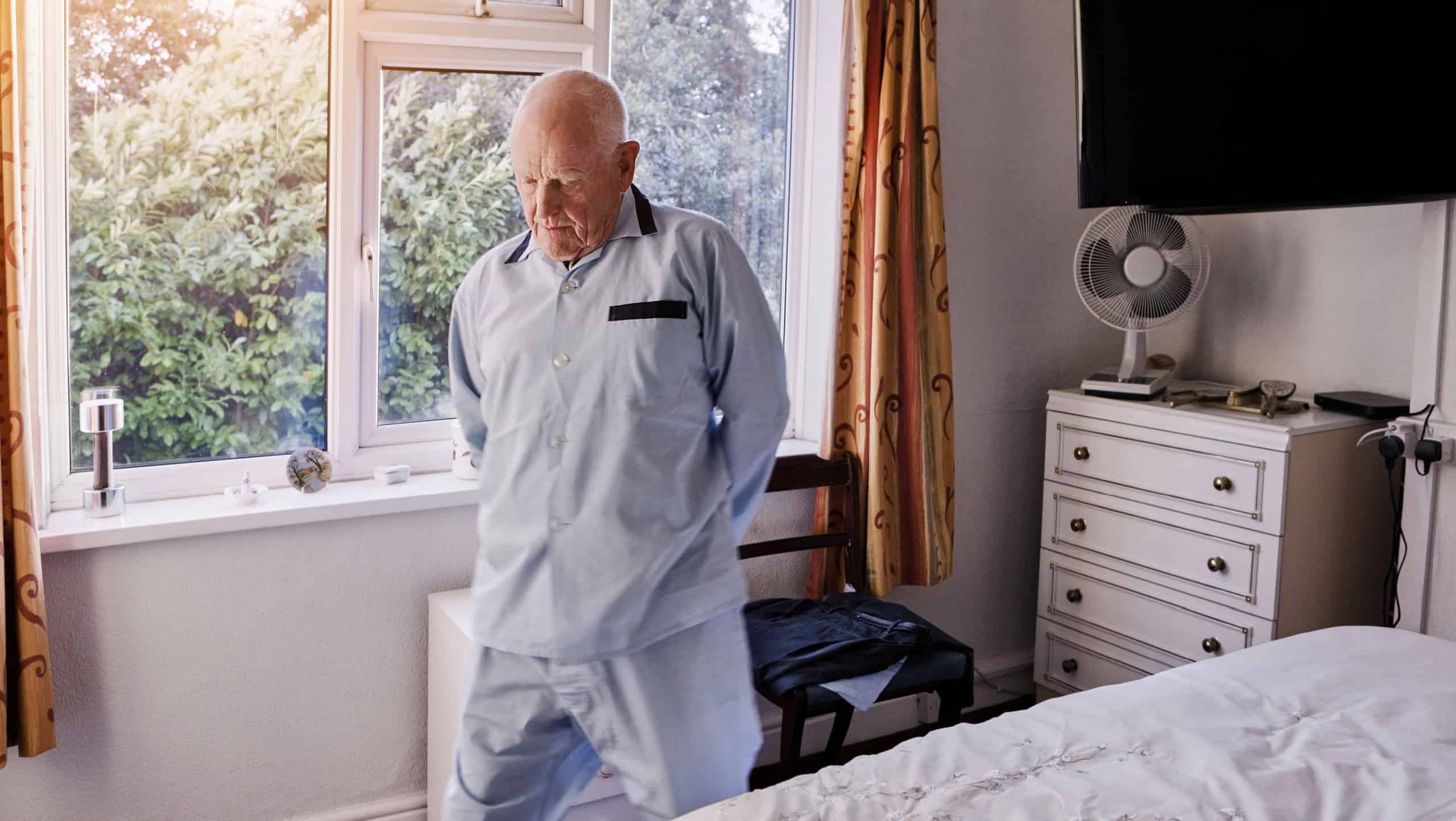 Morning, retirement and senior man in bedroom for wake up, start and getting ready for the day. Thinking, house and elderly person by window with nostalgia, reflection and memory of past in home