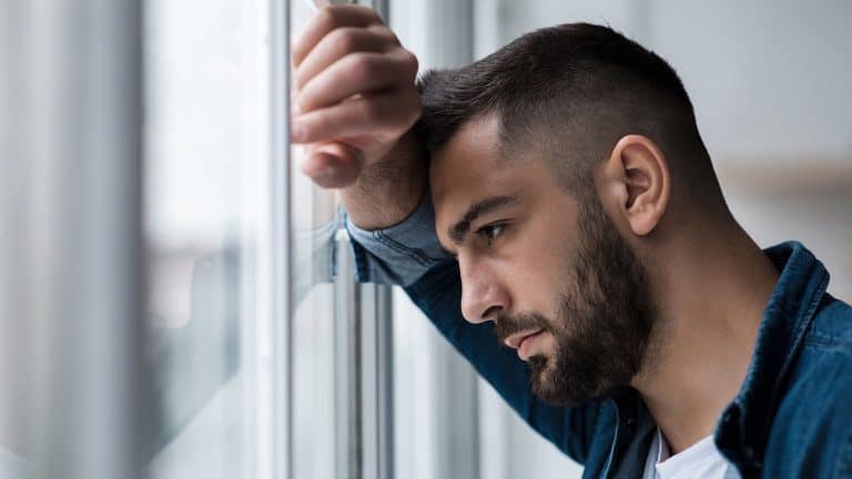 Depressed caucasian man losing job and heartbroken at same time alone, feeling bad and expresses negative