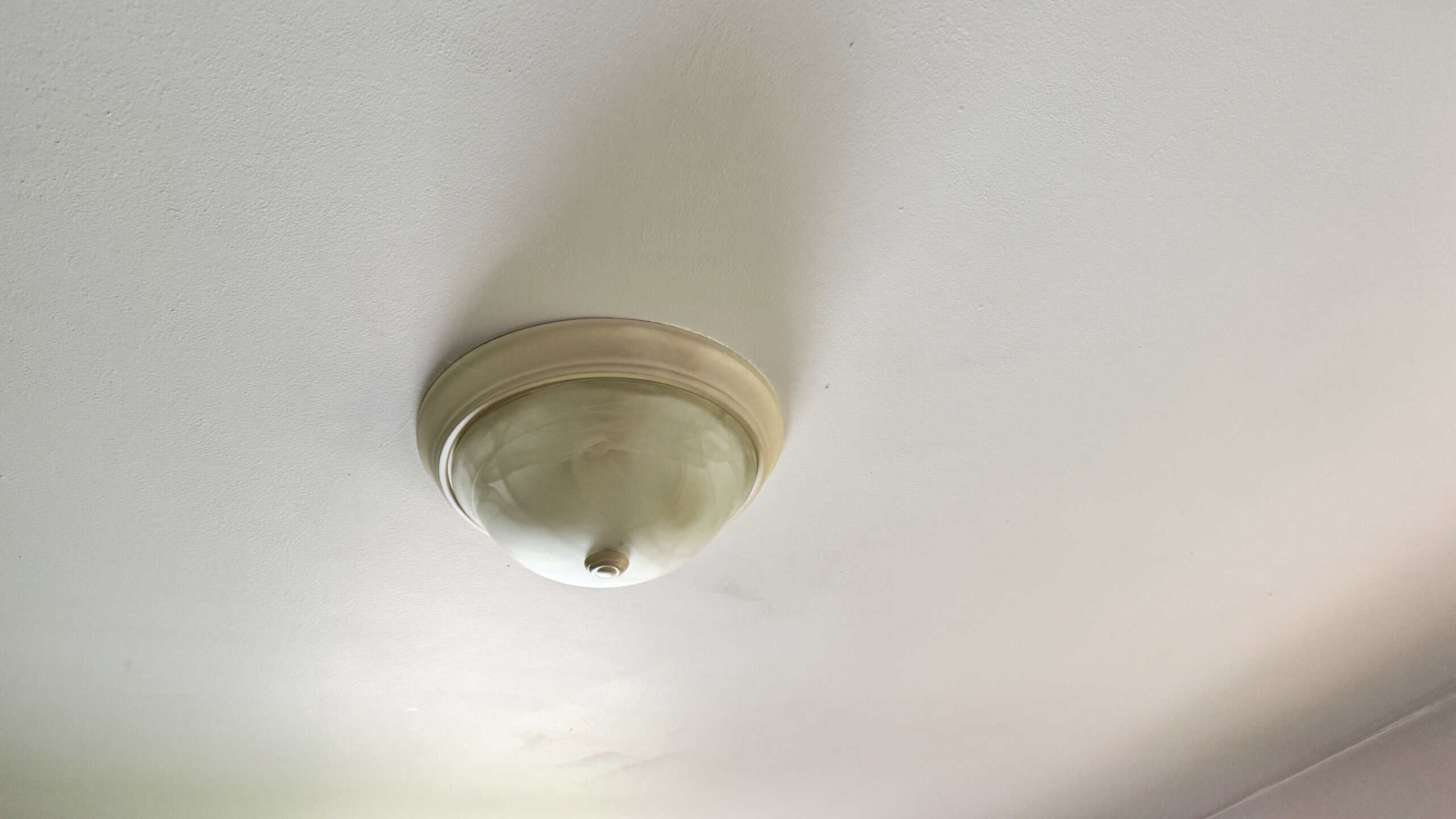 Round light fixture, builder grade, found in many American homes