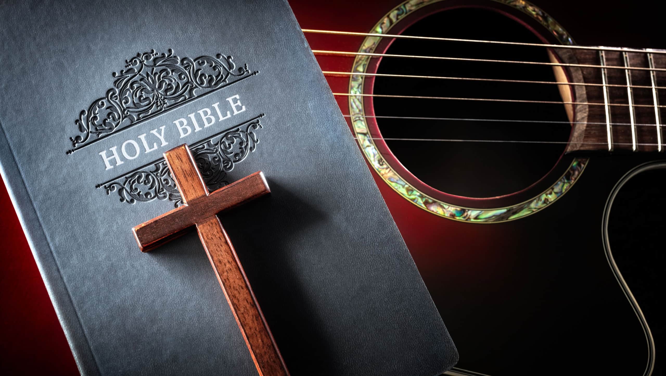 Holy Bible with acoustic guitar and religious crucifix cross, gospel music concept