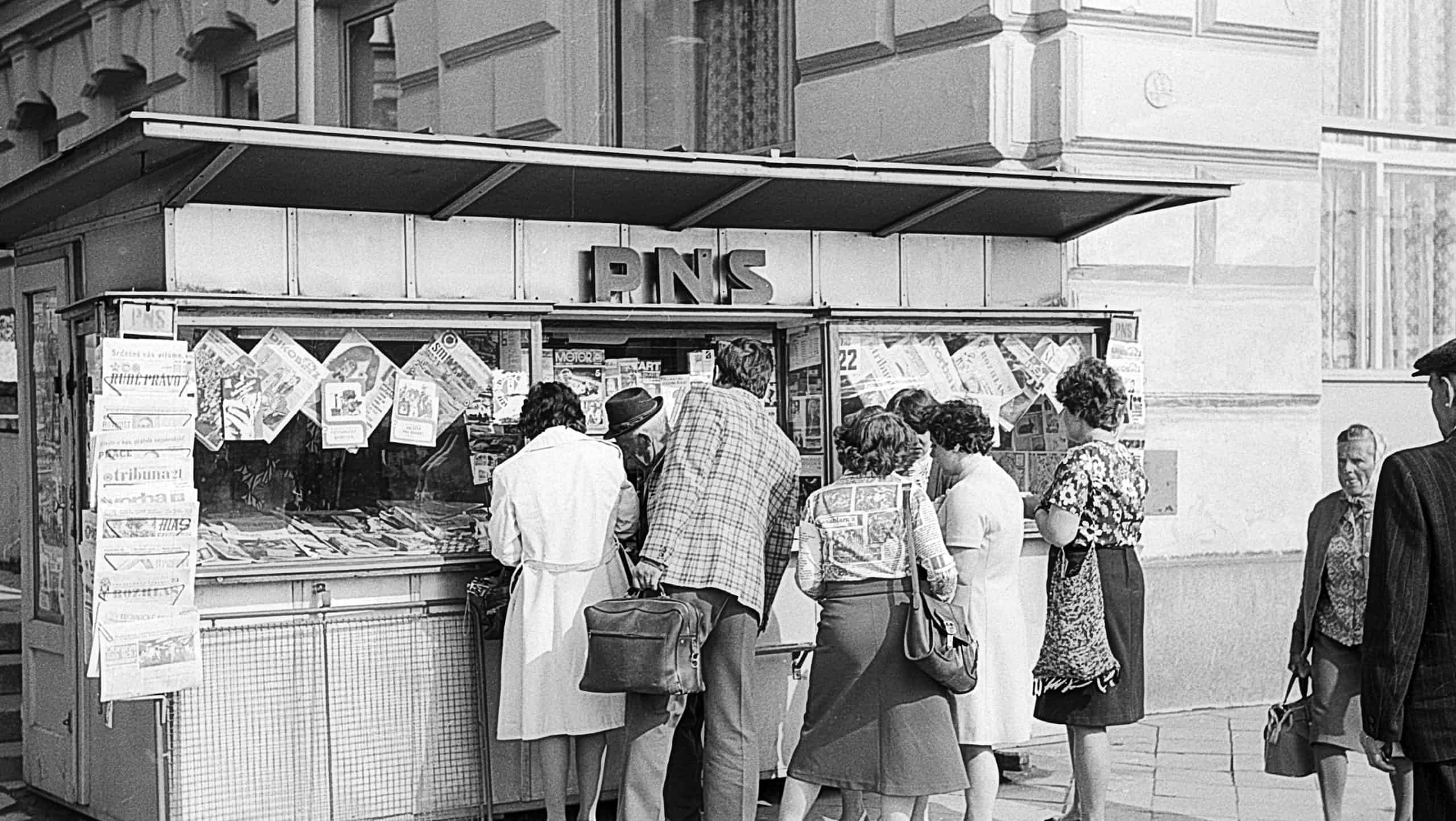 Brno, Czech, - June 1, 1978: people stand near PNS kiosk with newspapers and magazines to near Grand Hotel