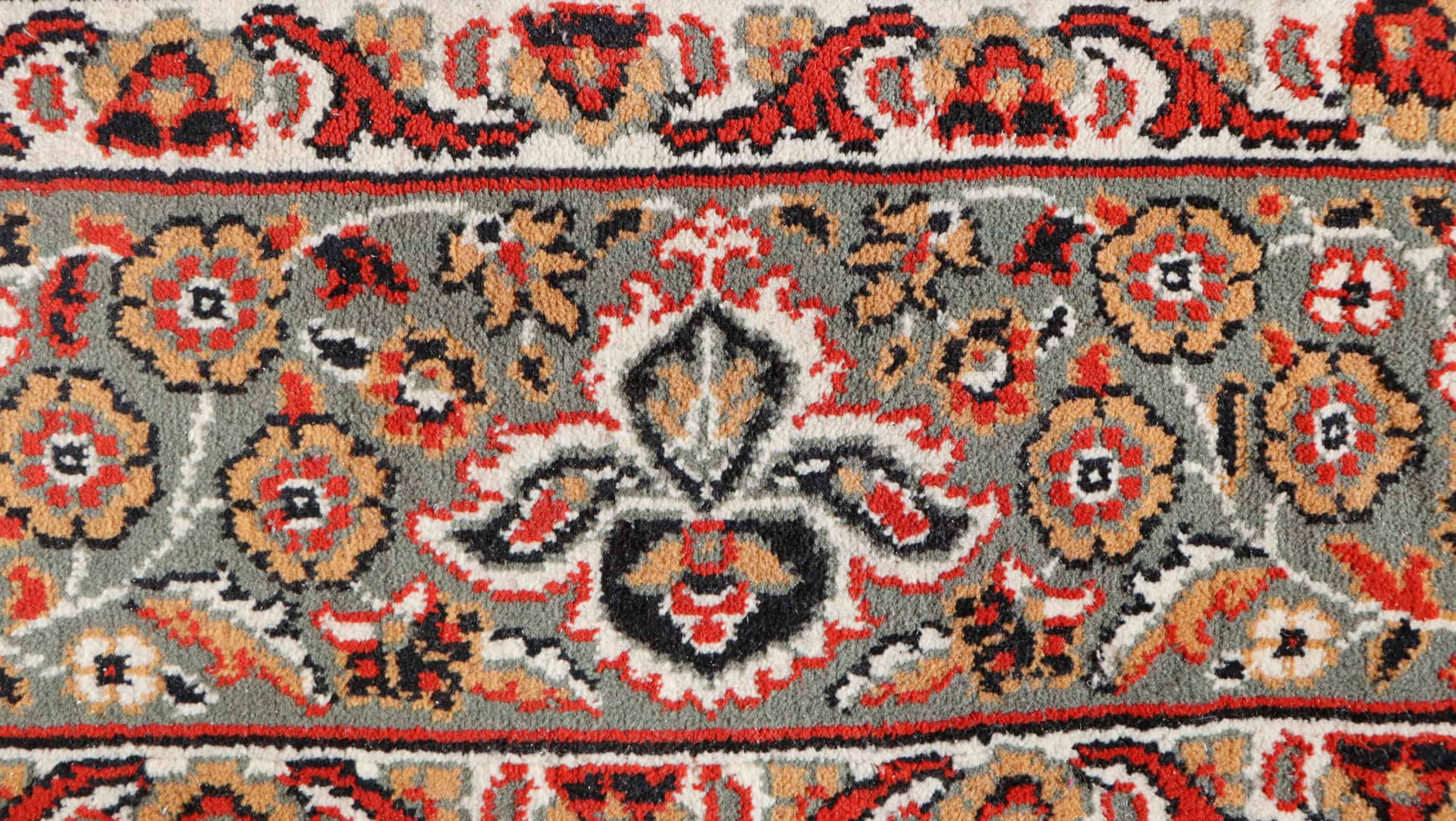 Turkish carpet photo.Top view of an old wool rug with a floral pattern.
