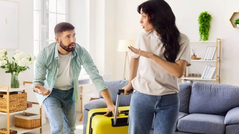Couple conflict at home, wife refusal to husband request to forgive for cheating and betrayal. Guilty sad man pleading, girl leaving with suitcase and rejection gesture, ultimatum in conversation