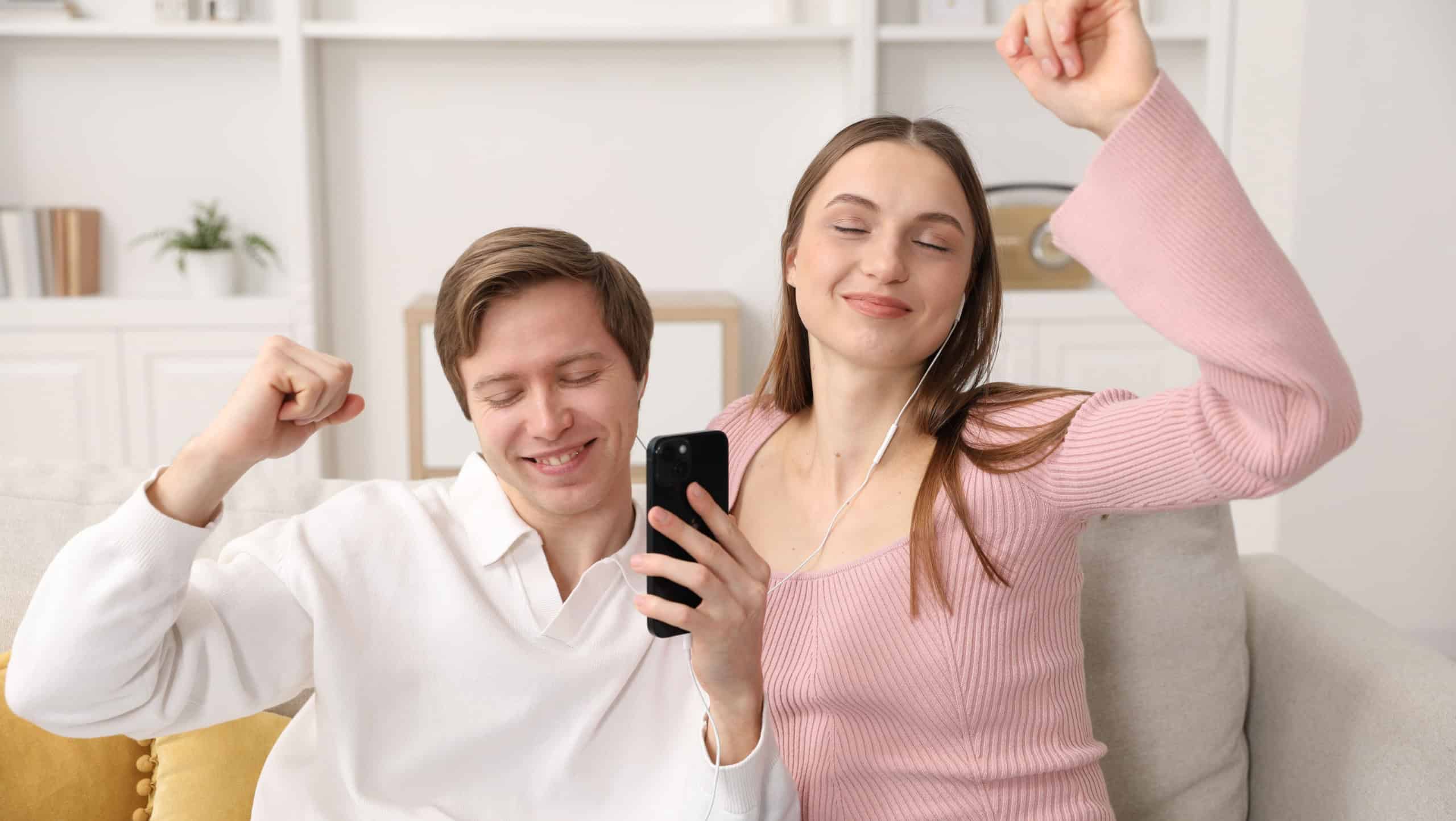 Date. Lovely couple listening to music together indoors