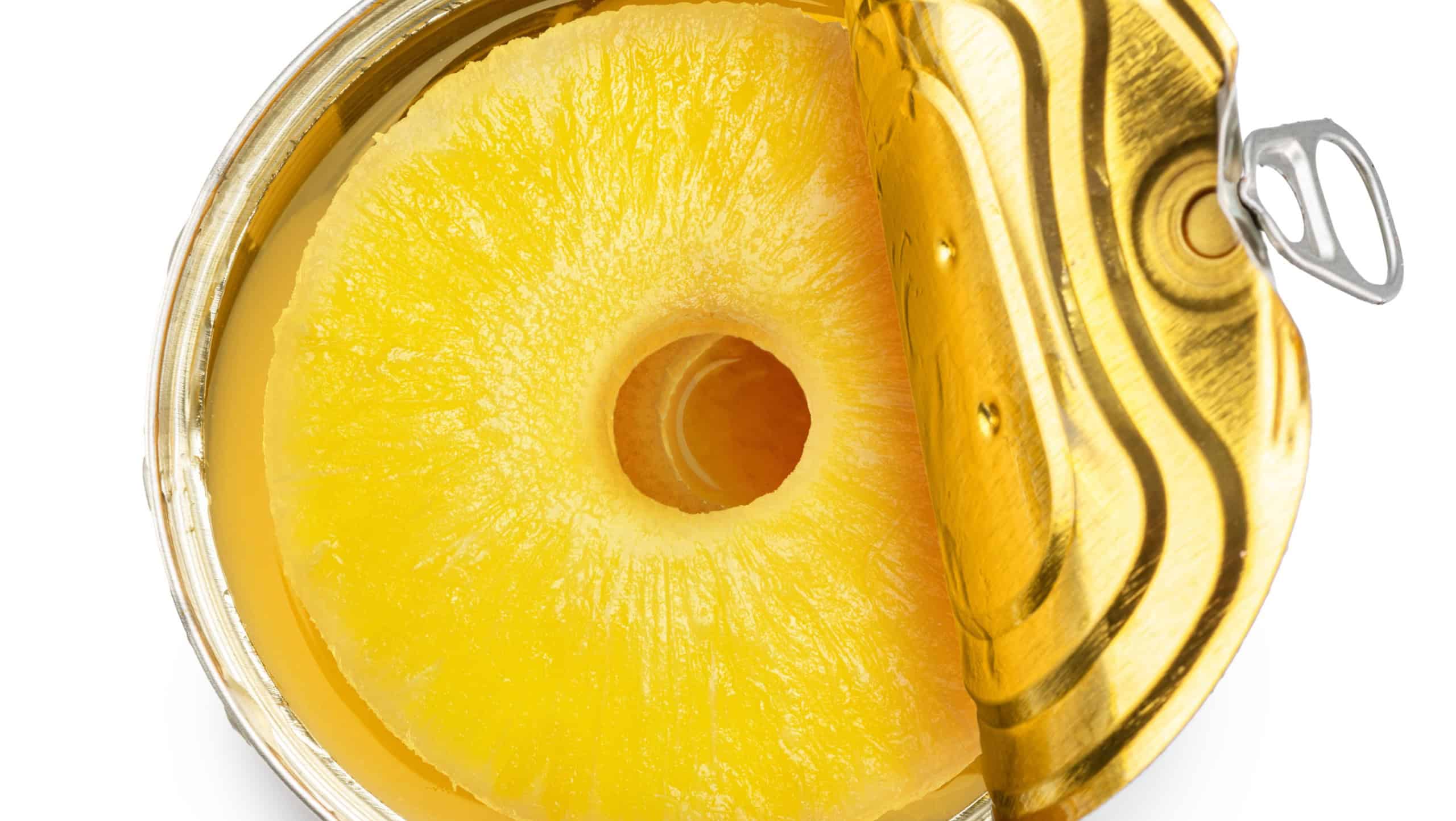 Pineapple rings in a tin can isolated on white background. Clipping path