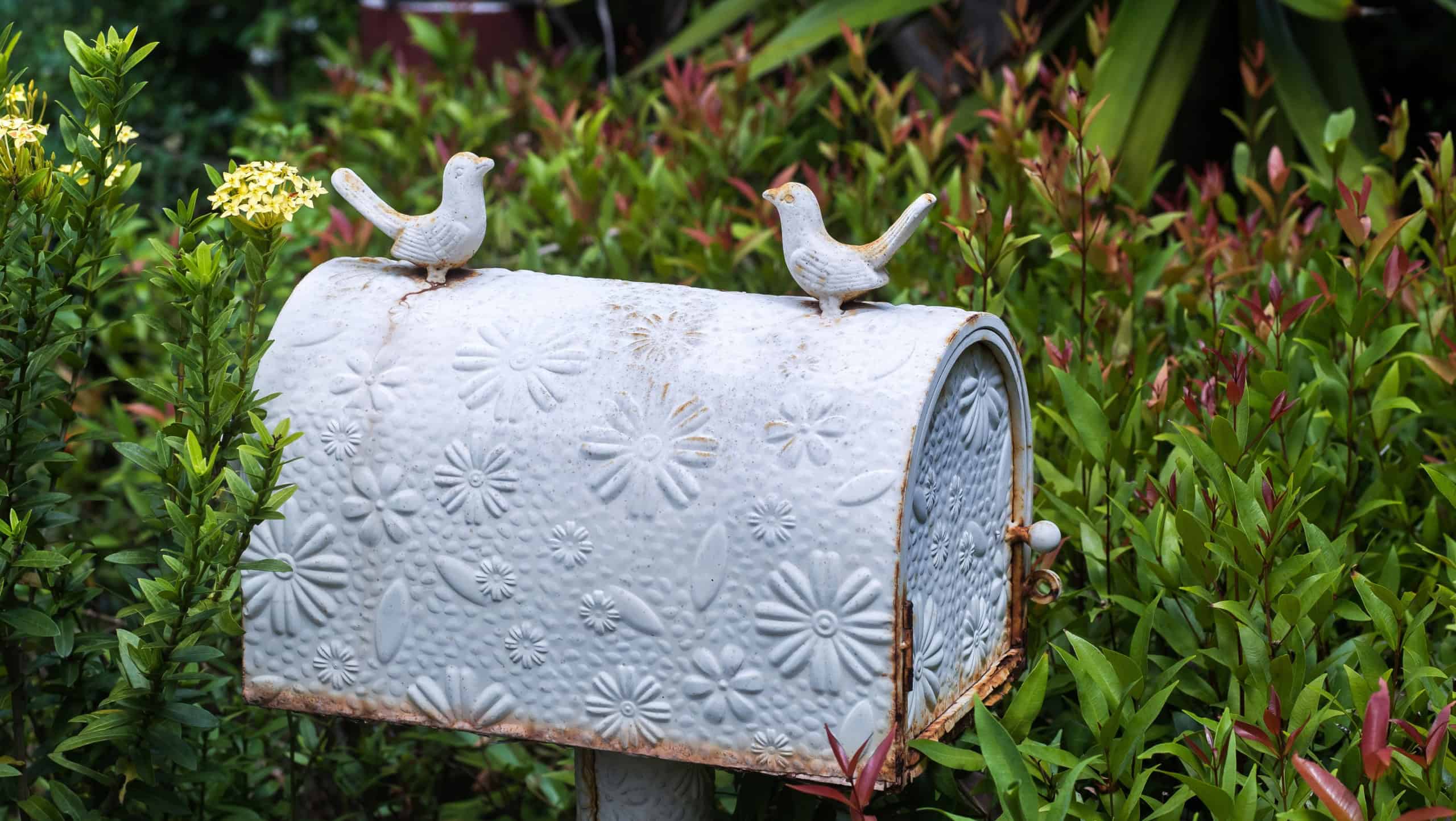 Old vintage white postbox with flowers pattern