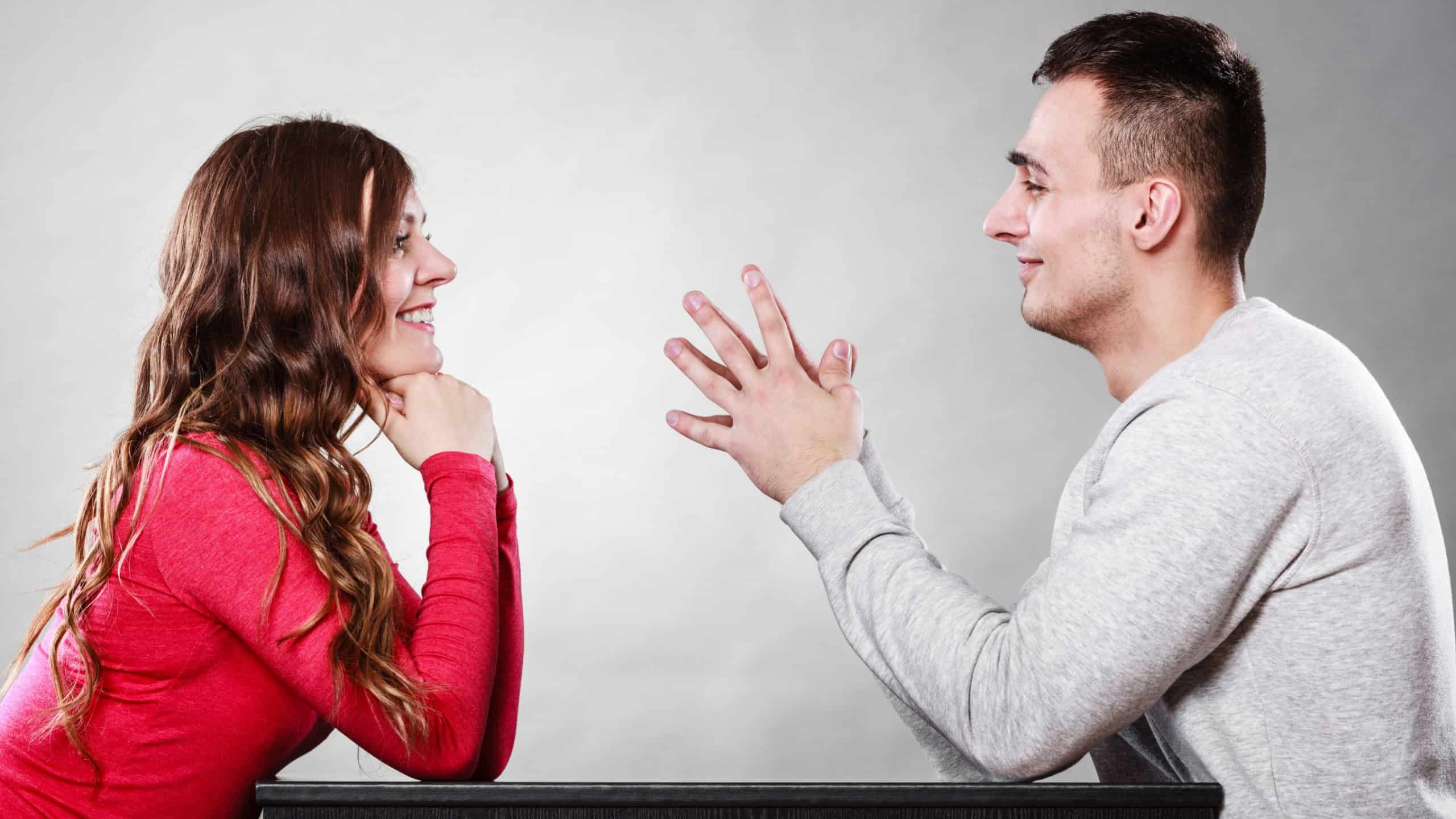 Happy couple talking and laughing on date. Smiling girl and guy having conversation. Amusing man making woman laugh. Good relationship.