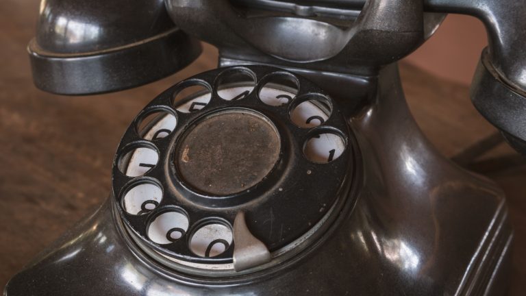 Vintage - Old Black phone retro on a wood table - 80's concept image