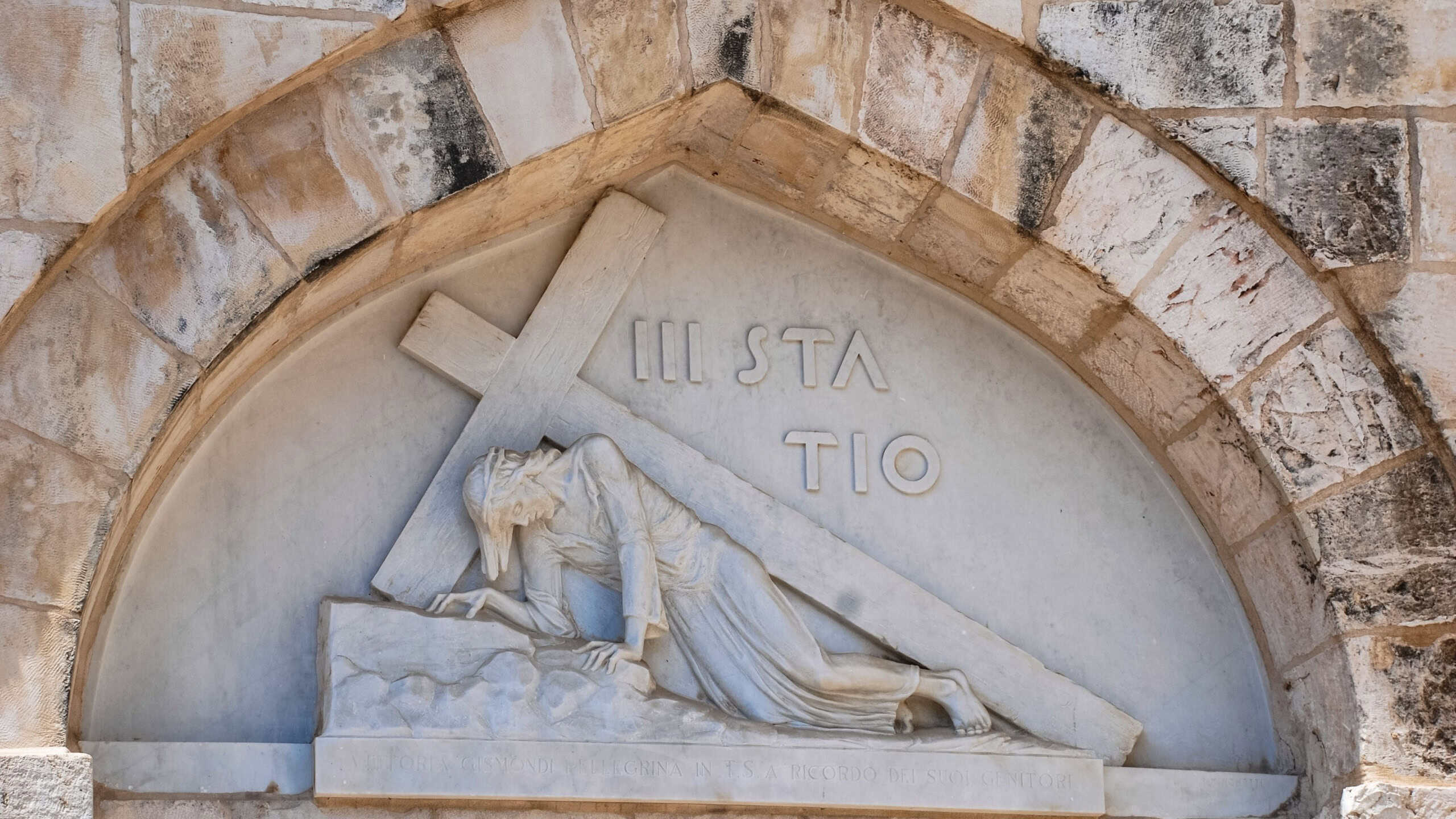 Horizontal picture of marble art of Jesus Christ with crucifix at Christian Quarter inside the walls of Old City in Jerusalem, Israel