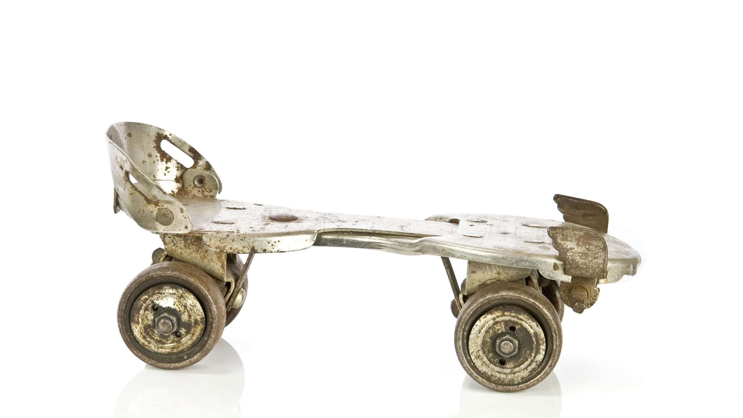 Old clamp-on roller skate on white