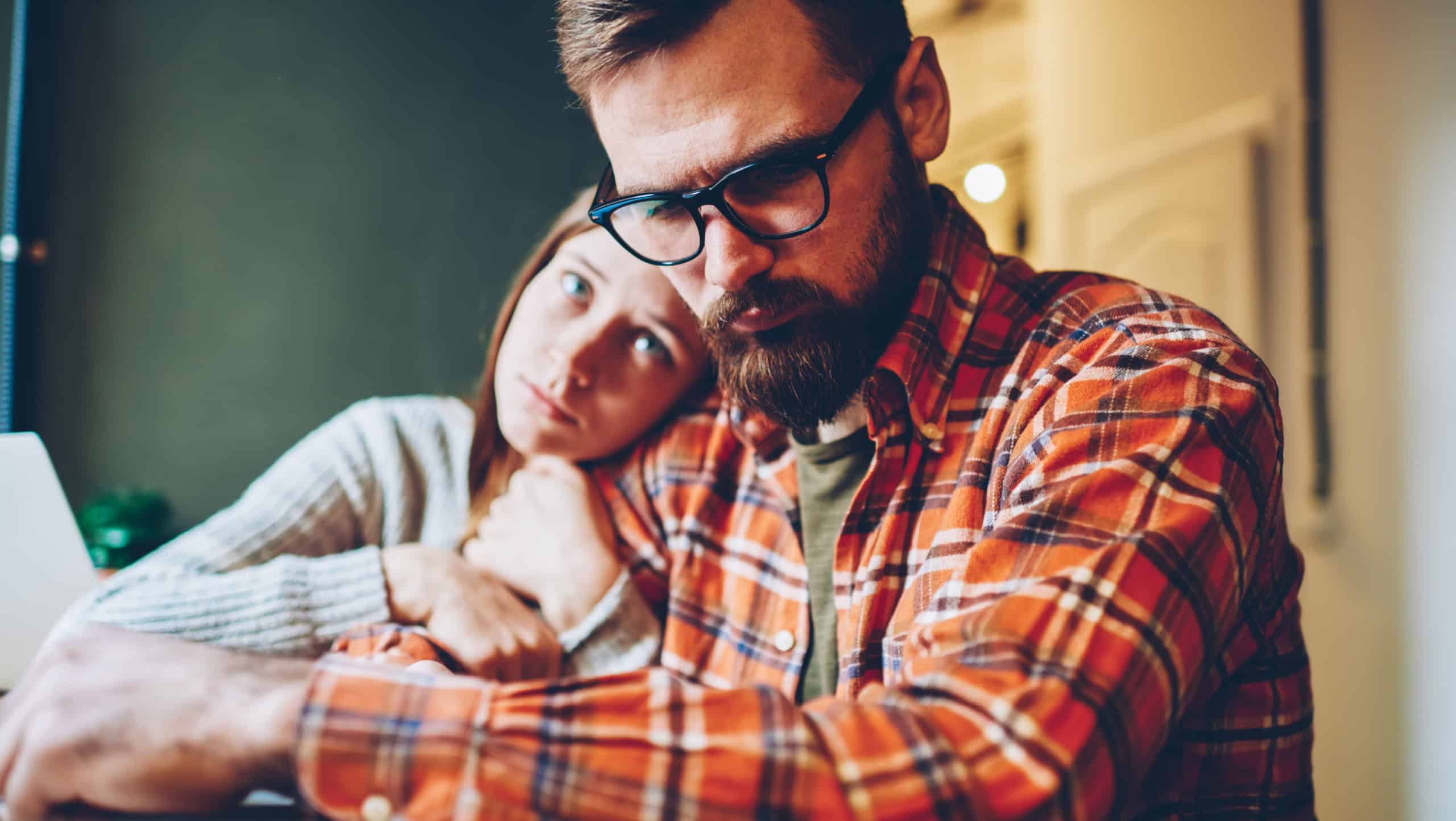 Loving young woman support her unmotivated boyfriend hugging and consoling during working difficulties.Compassionate hipster girl comforting desperate male designer after defeat sitting at home